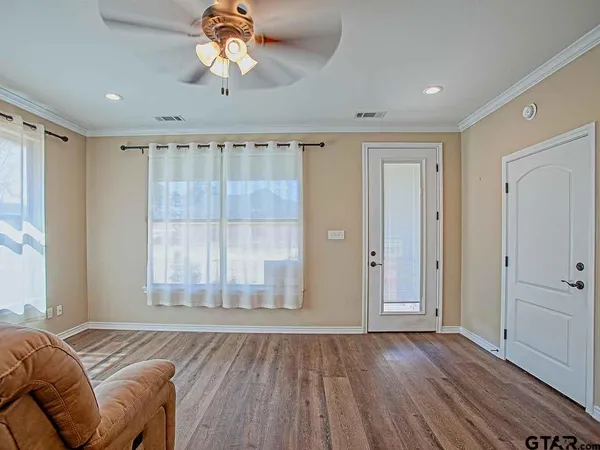 a view of a bedroom with a bed and a window
