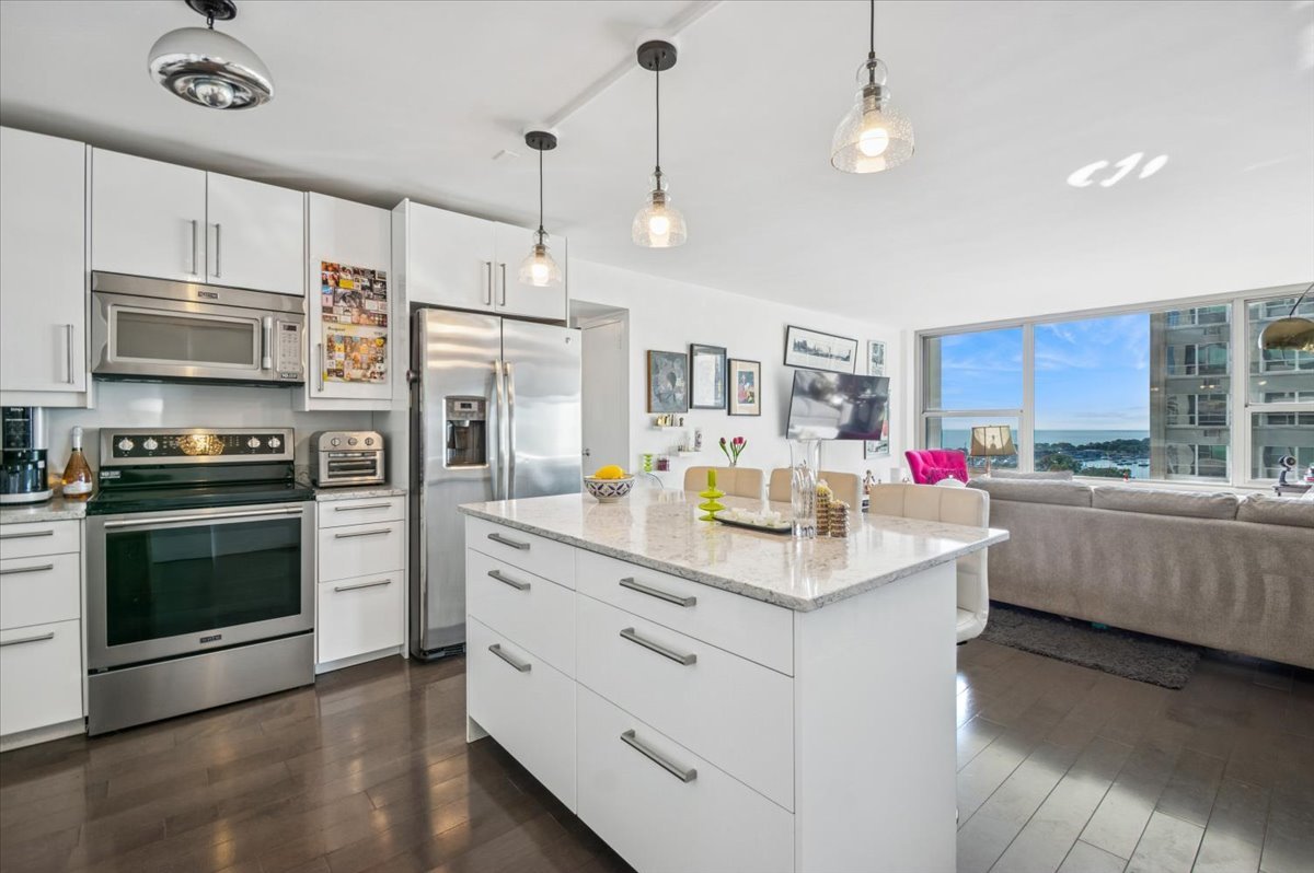 3600 North Lake Shore Drive, Unit 1601 Chicago, IL 60613 - Photo 3 of 16 a kitchen with stainless steel appliances kitchen island granite countertop a stove and a sink