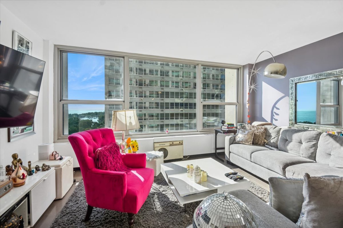 3600 North Lake Shore Drive, Unit 1601 Chicago, IL 60613 - Photo 6 of 16 a living room with furniture and a flat screen tv
