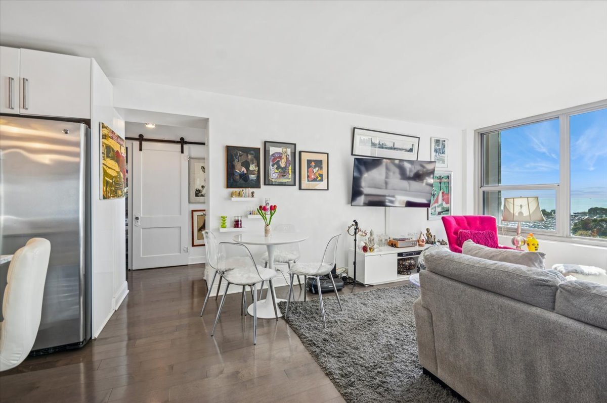 3600 North Lake Shore Drive, Unit 1601 Chicago, IL 60613 - Photo 7 of 16 a living room with furniture and a wooden floor