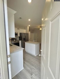 710 Rex Dr Spring Hill Spring Hill, TN 37174 - Photo 2 of 6 a kitchen with stainless steel appliances kitchen island a refrigerator sink and cabinets