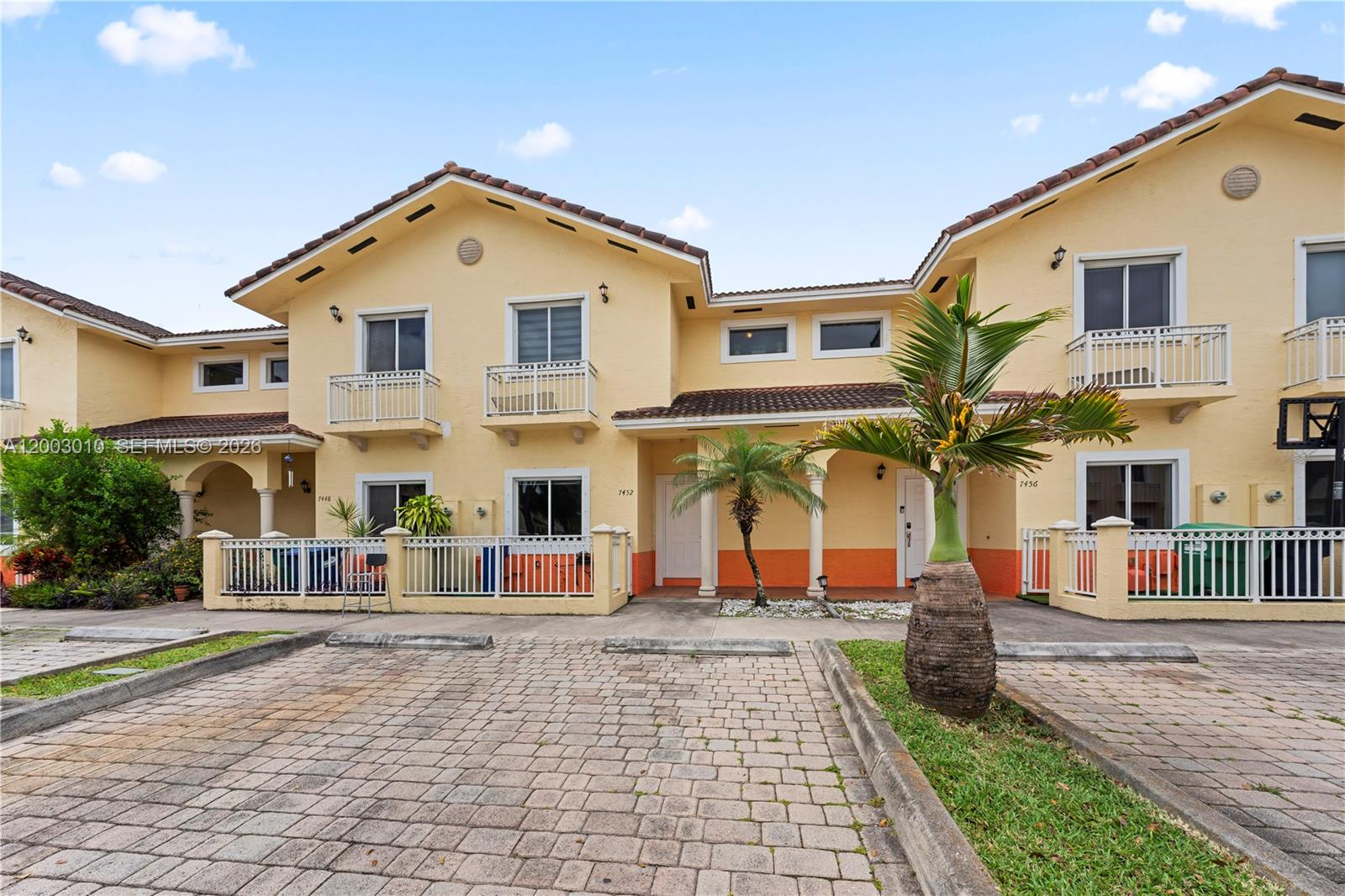 a front view of multiple houses with yard