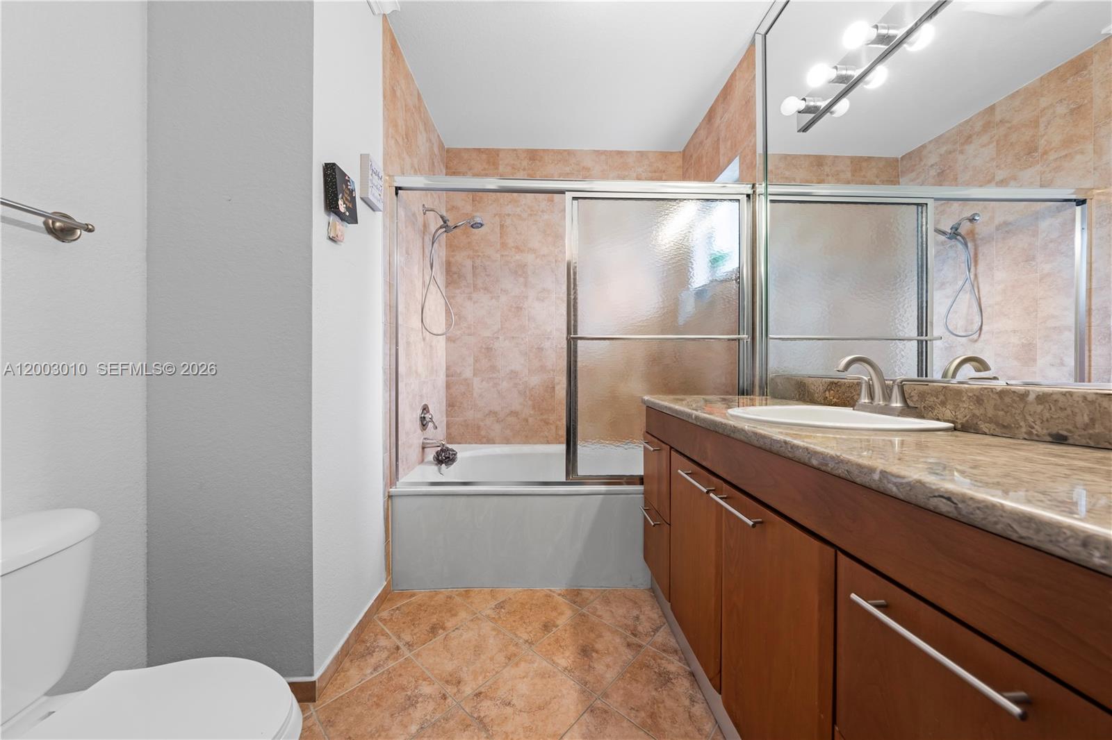7452 Northwest 178th Street Hialeah, FL 33015 - Photo 14 of 28 a bathroom with a granite countertop sink toilet and shower