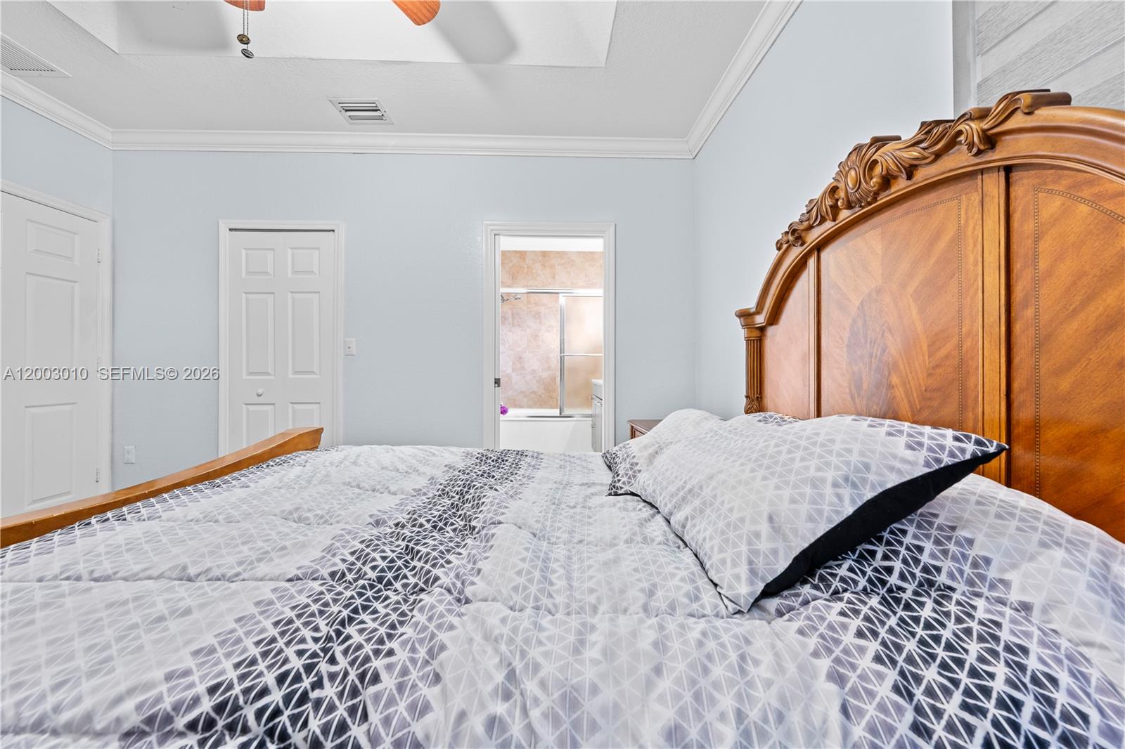 7452 Northwest 178th Street Hialeah, FL 33015 - Photo 15 of 28 a bedroom with a bed and a painting on the wall