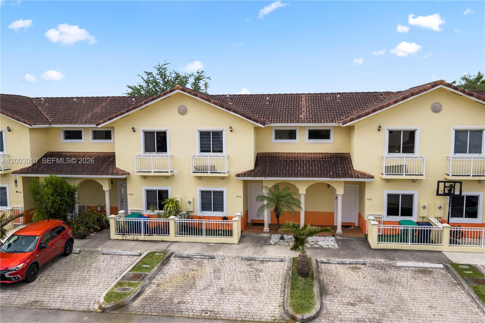 7452 Northwest 178th Street Hialeah, FL 33015 - Photo 2 of 28 a view of a white house with large windows and a table and chairs