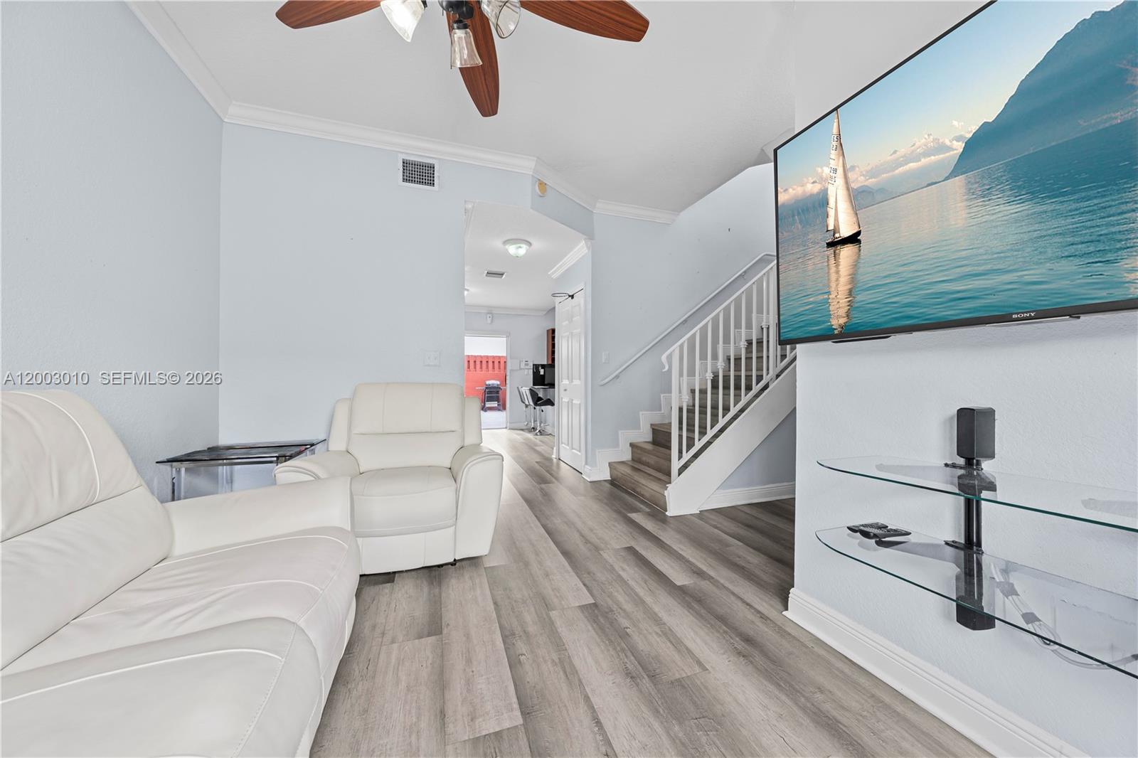 7452 Northwest 178th Street Hialeah, FL 33015 - Photo 3 of 28 a living room with furniture and a chandelier