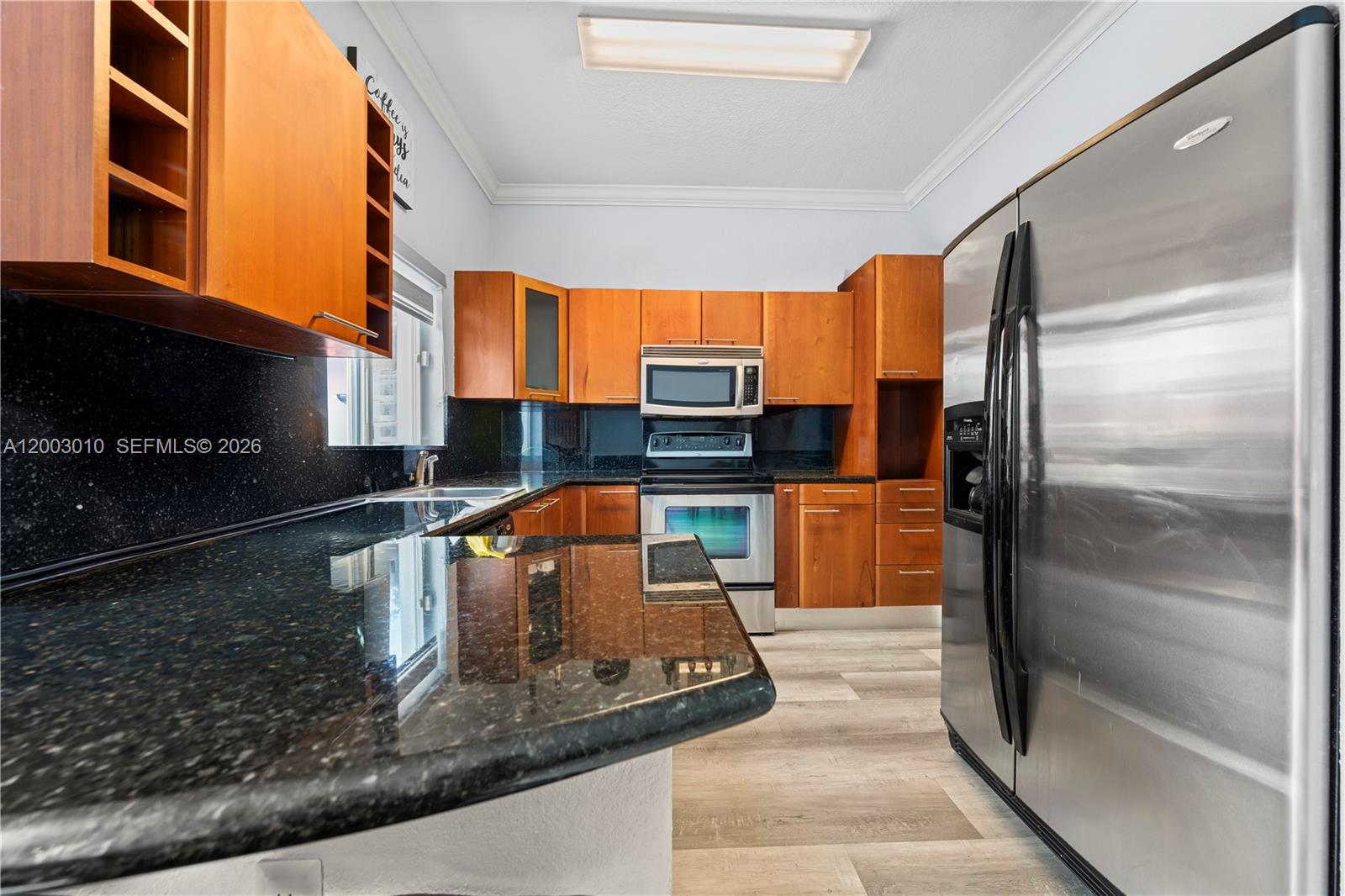 7452 Northwest 178th Street Hialeah, FL 33015 - Photo 5 of 28 a kitchen with stainless steel appliances granite countertop a refrigerator and a stove