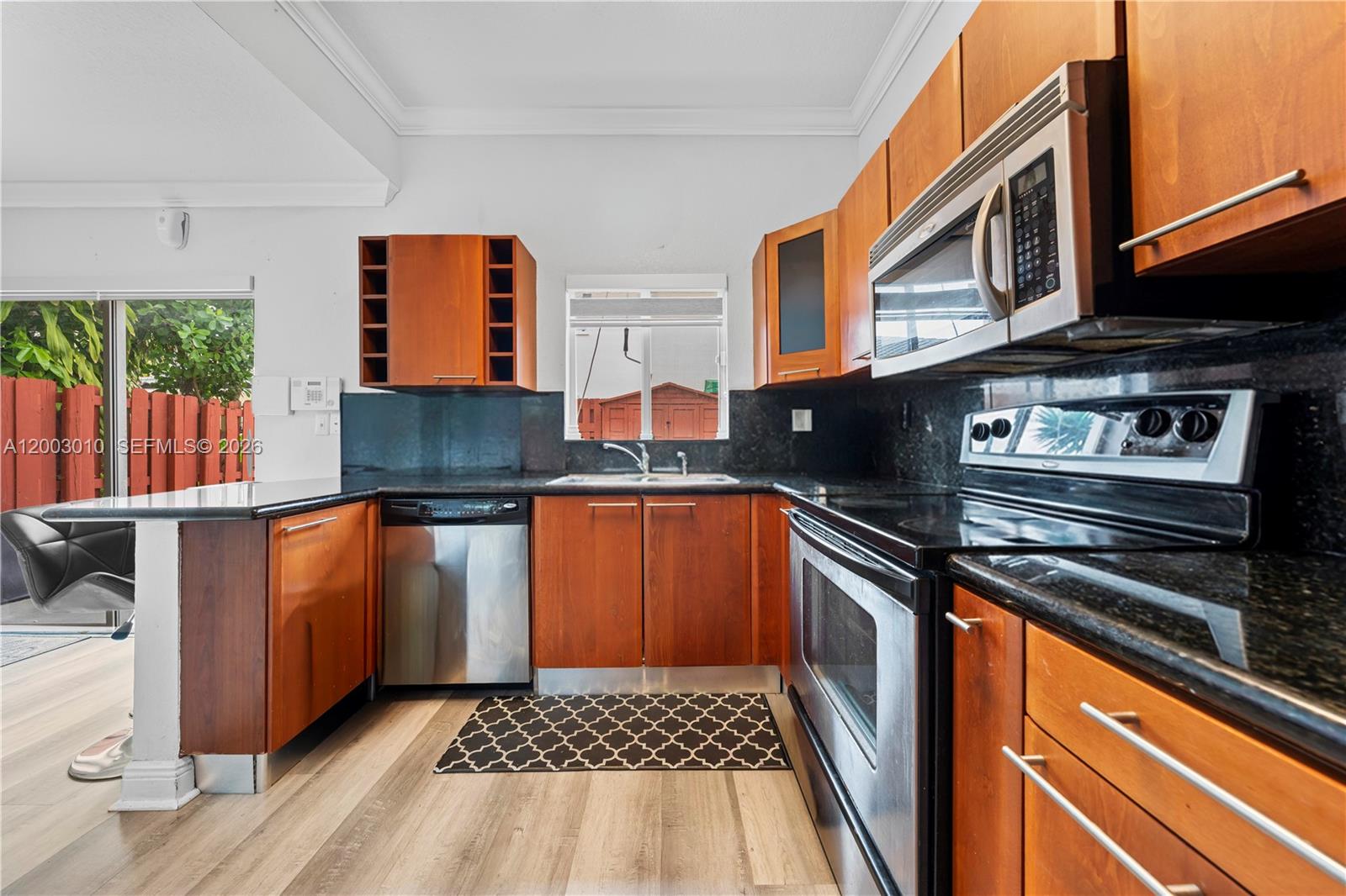 7452 Northwest 178th Street Hialeah, FL 33015 - Photo 6 of 28 a kitchen with granite countertop a stove and a sink