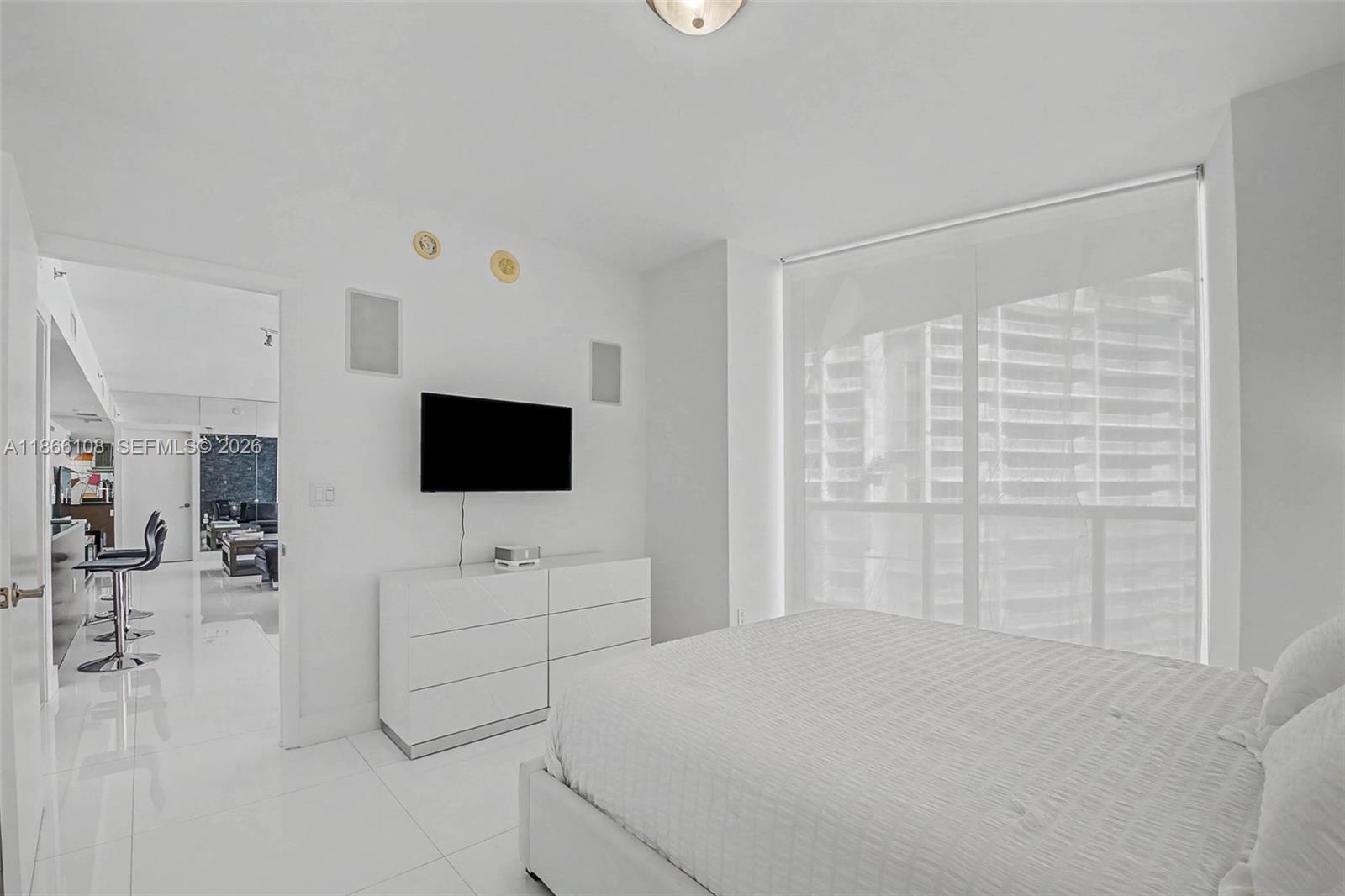 495 Brickell Avenue, Unit 3504 Miami, FL 33131 - Photo 11 of 43 a bedroom with a bed tv and a couch