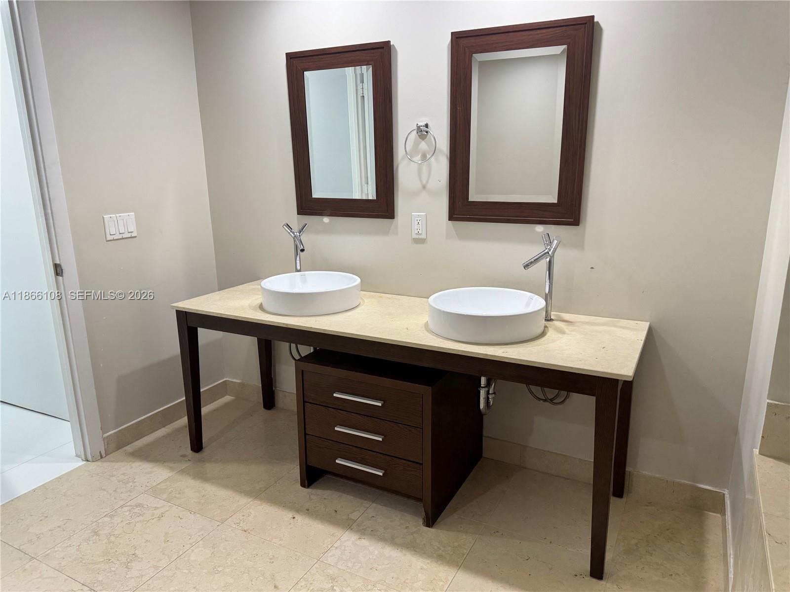 495 Brickell Avenue, Unit 3504 Miami, FL 33131 - Photo 12 of 14 a bathroom with a sink and a mirror