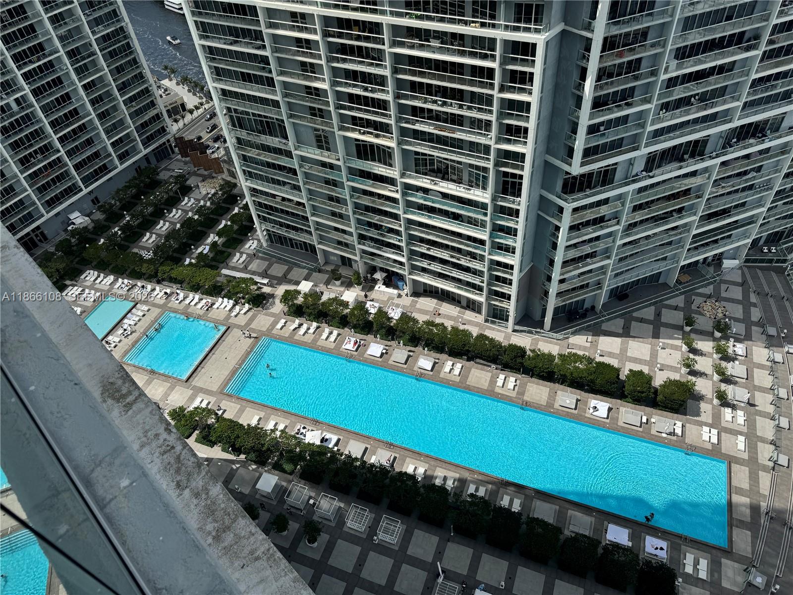 495 Brickell Avenue, Unit 3504 Miami, FL 33131 - Photo 13 of 43 a view of a pool with a outdoor seating