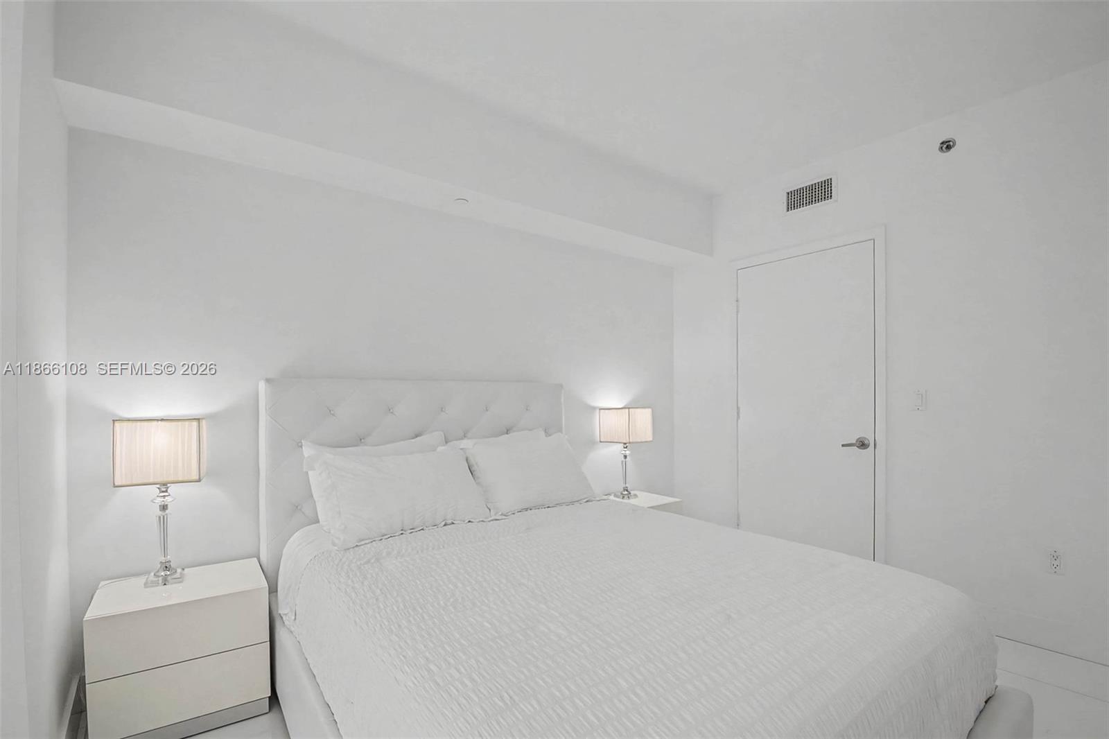 495 Brickell Avenue, Unit 3504 Miami, FL 33131 - Photo 17 of 43 a bedroom with a bed and a night stand