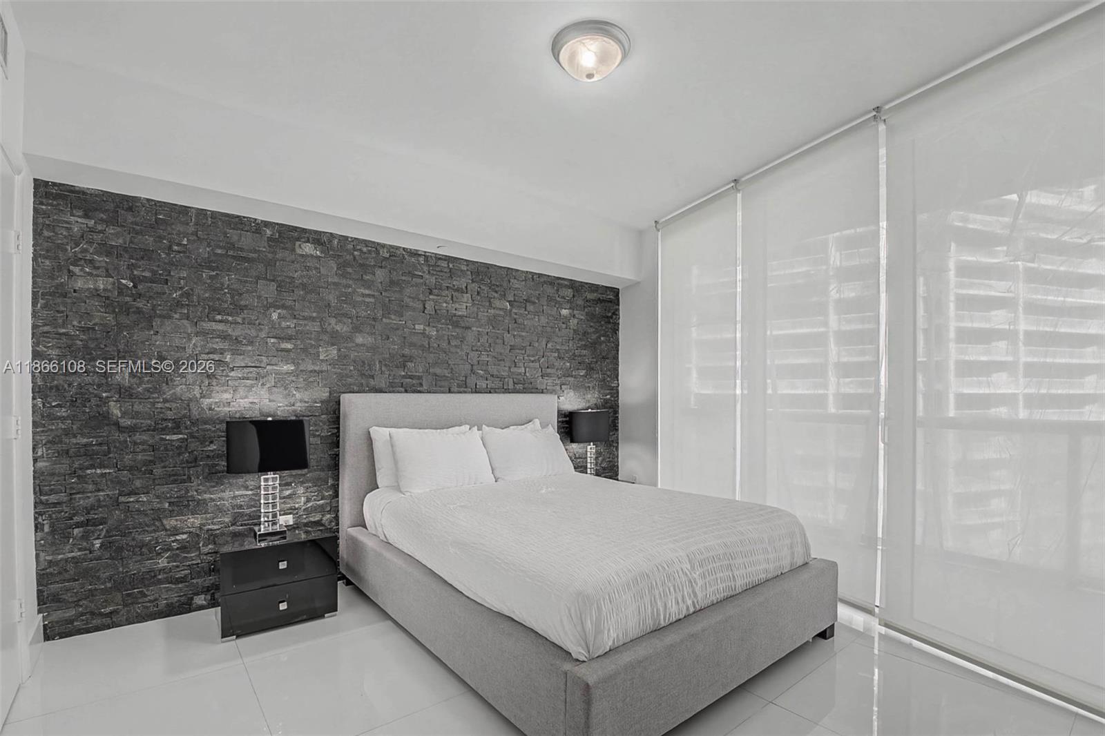 495 Brickell Avenue, Unit 3504 Miami, FL 33131 - Photo 18 of 43 a bedroom with a bed and a fireplace