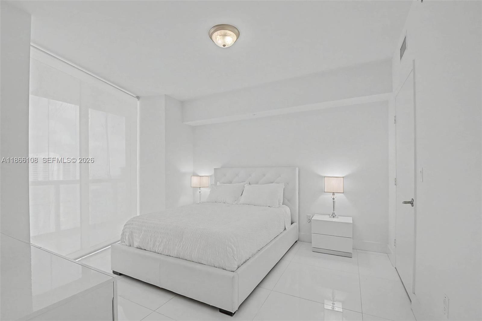 495 Brickell Avenue, Unit 3504 Miami, FL 33131 - Photo 20 of 43 a room with a bed and a night stand