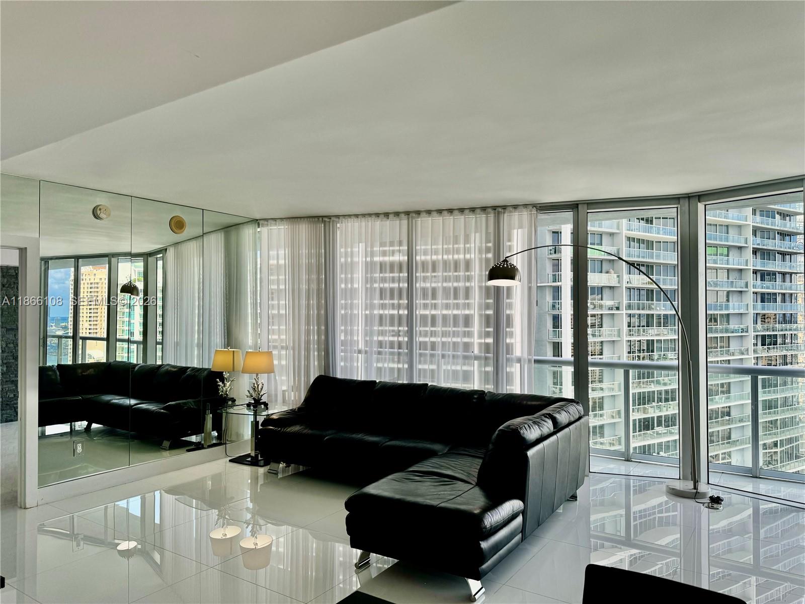495 Brickell Avenue, Unit 3504 Miami, FL 33131 - Photo 22 of 43 a living room with furniture and a window