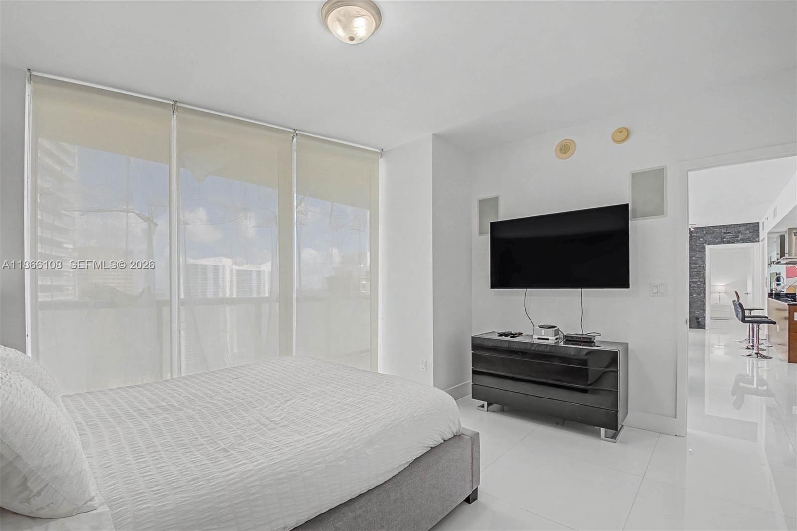 495 Brickell Avenue, Unit 3504 Miami, FL 33131 - Photo 30 of 43 a bedroom with a bed and a flat screen tv