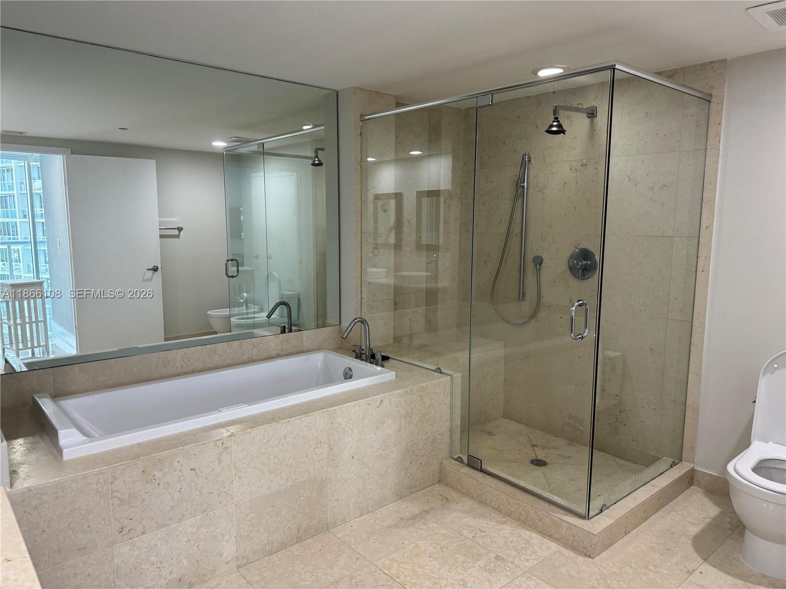 495 Brickell Avenue, Unit 3504 Miami, FL 33131 - Photo 6 of 14 a spacious bathroom with a shower and a toilet