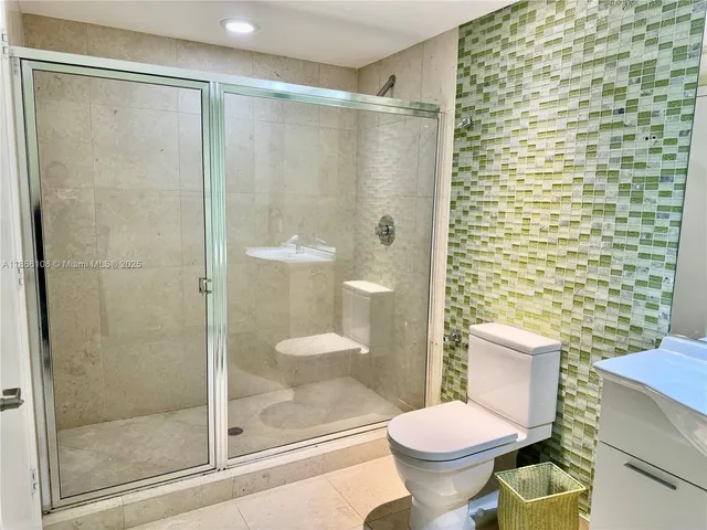 a bathroom with a shower and a toilet