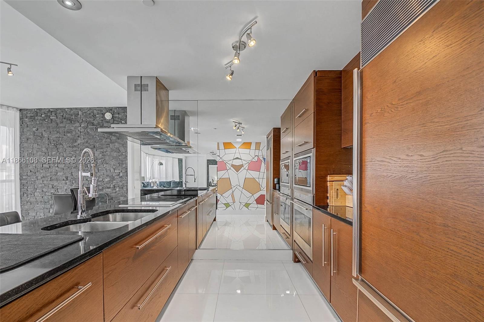 495 Brickell Avenue, Unit 3504 Miami, FL 33131 - Photo 7 of 43 a large kitchen with stainless steel appliances granite countertop a lot of counter space and a sink