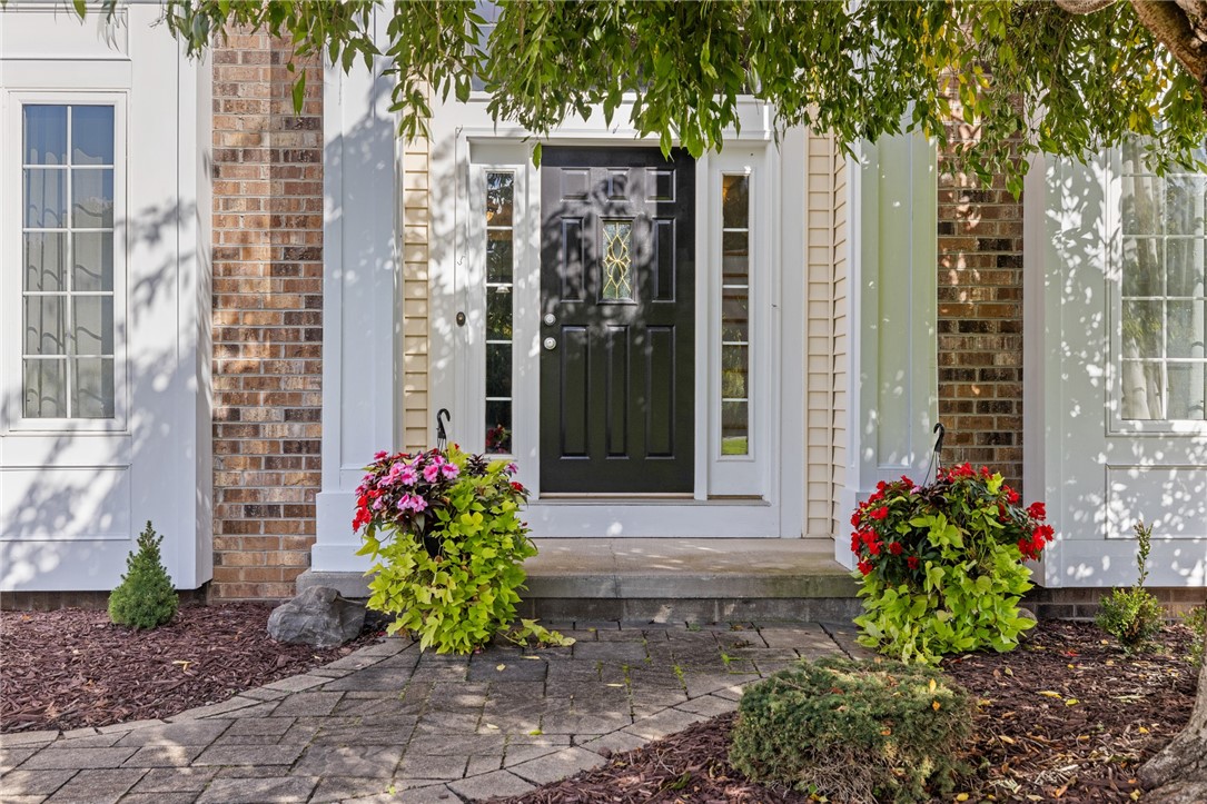 1782 Sweets Corners Road Penfield, NY 14450 - Photo 5 of 49 A welcoming front entrance featuring brick accents and a stone pathway.