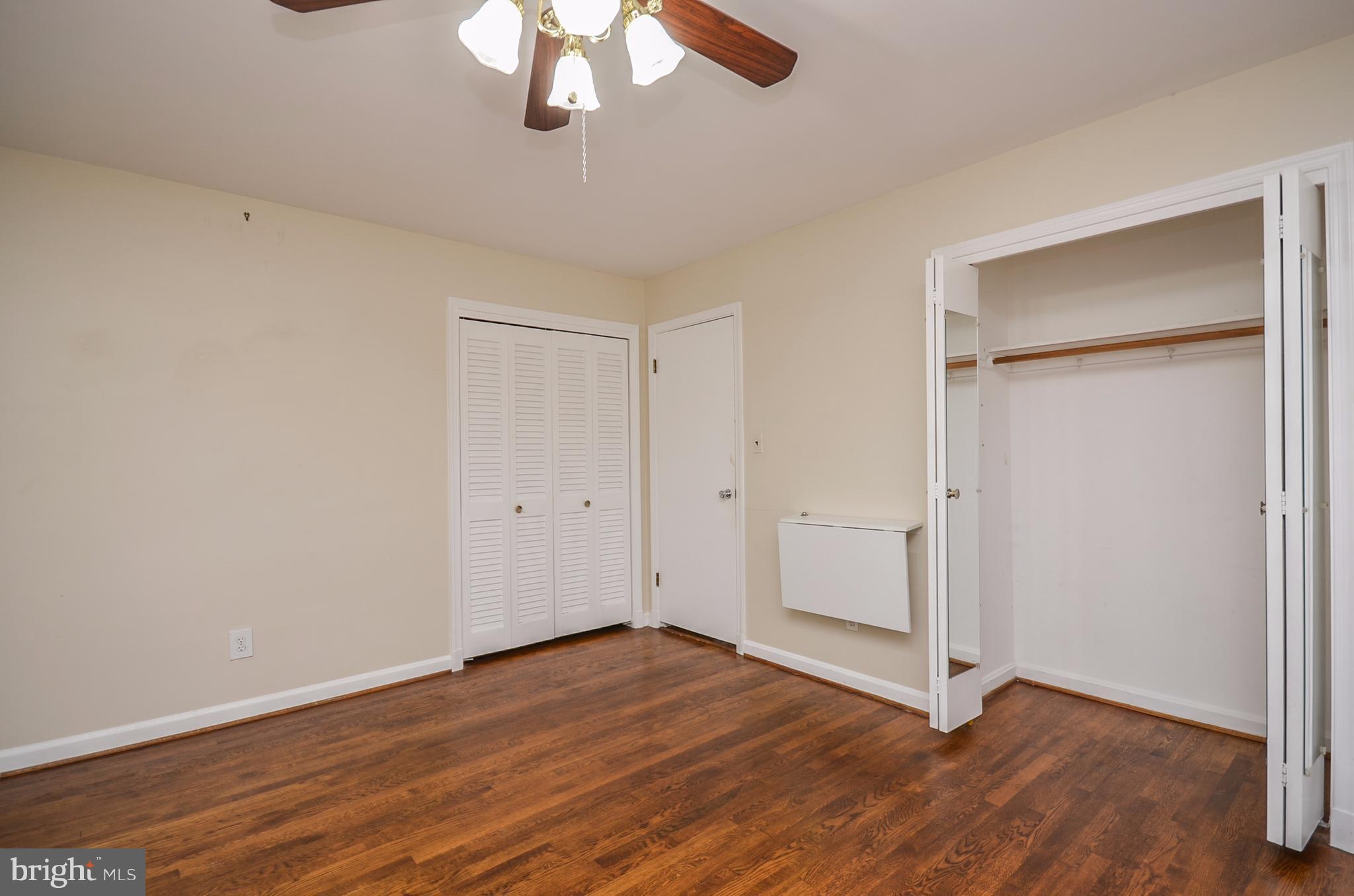 10751 Kinloch Road Silver Spring, MD 20903 - Photo 11 of 30 a view of an empty room with wooden floor