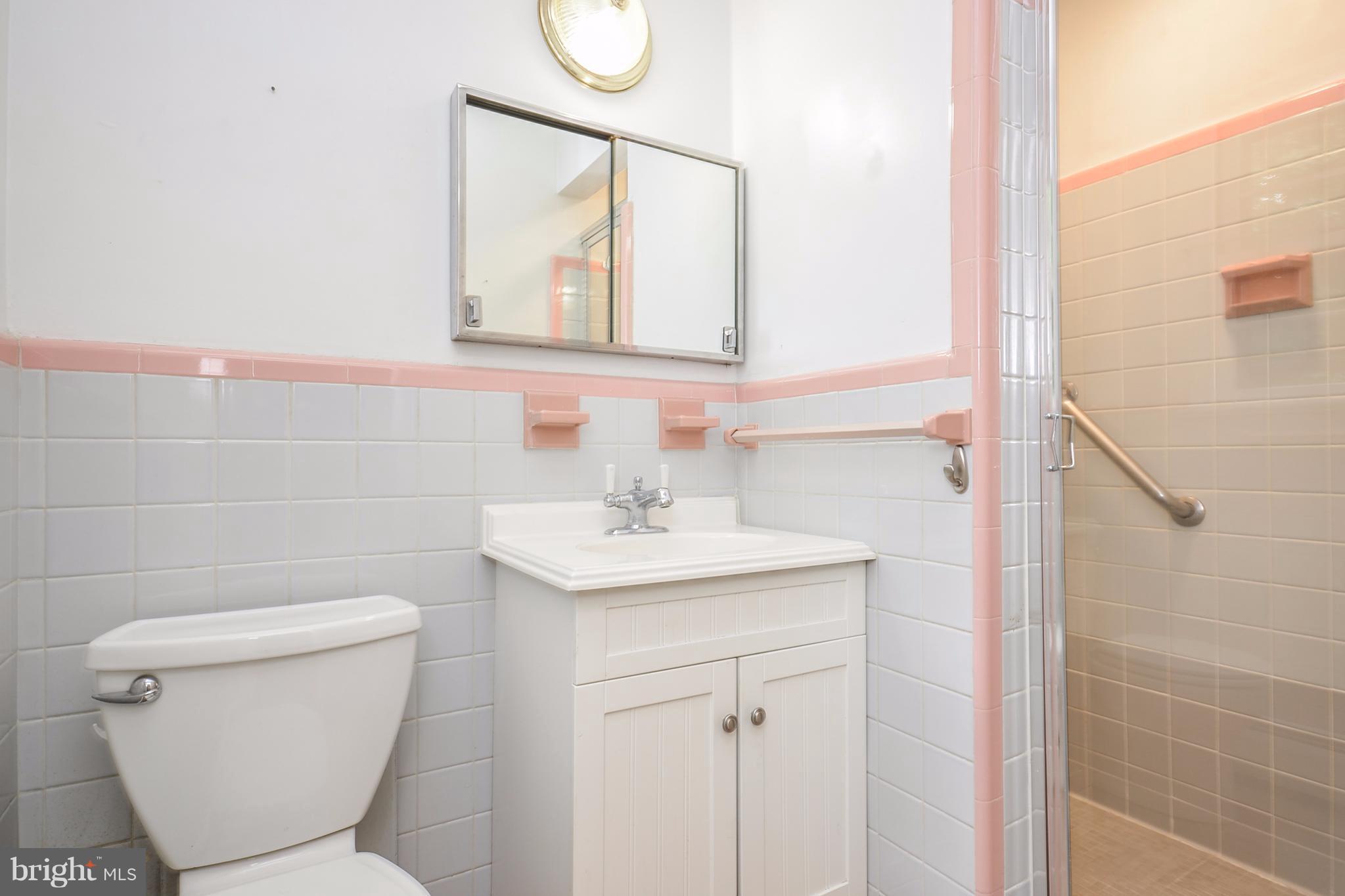 10751 Kinloch Road Silver Spring, MD 20903 - Photo 12 of 30 a bathroom with a toilet sink and mirror