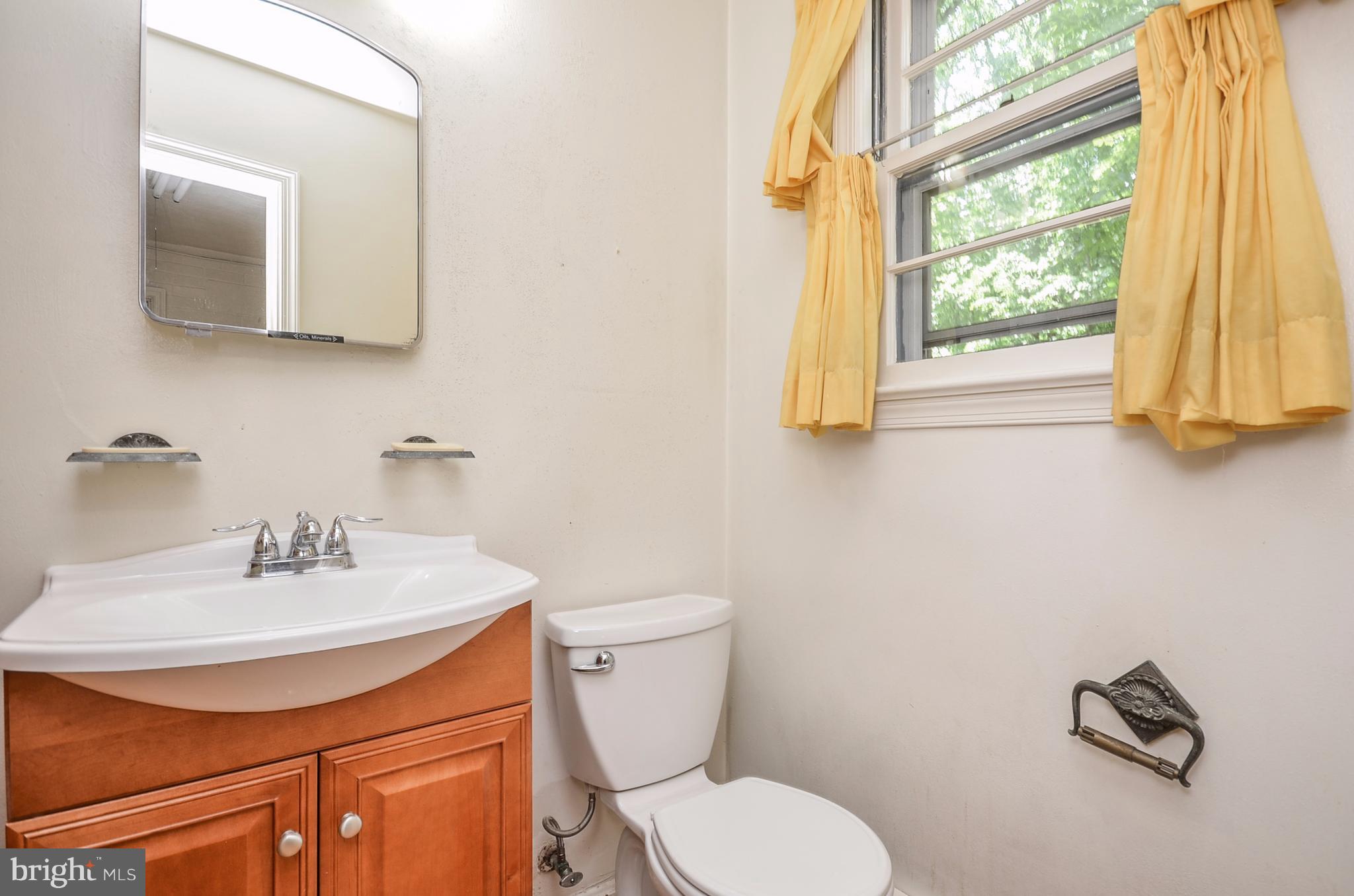 10751 Kinloch Road Silver Spring, MD 20903 - Photo 20 of 30 a bathroom with a sink mirror and toilet