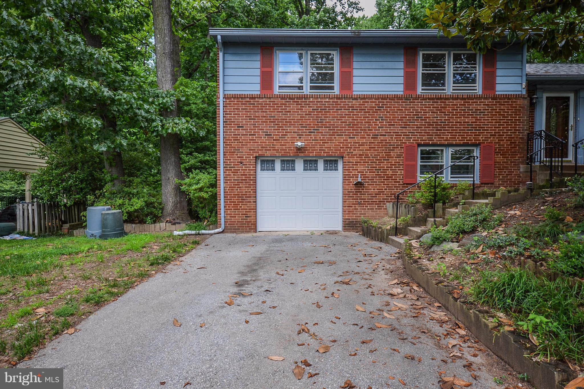10751 Kinloch Road Silver Spring, MD 20903 - Photo 30 of 30 a front view of a house with a yard and garage