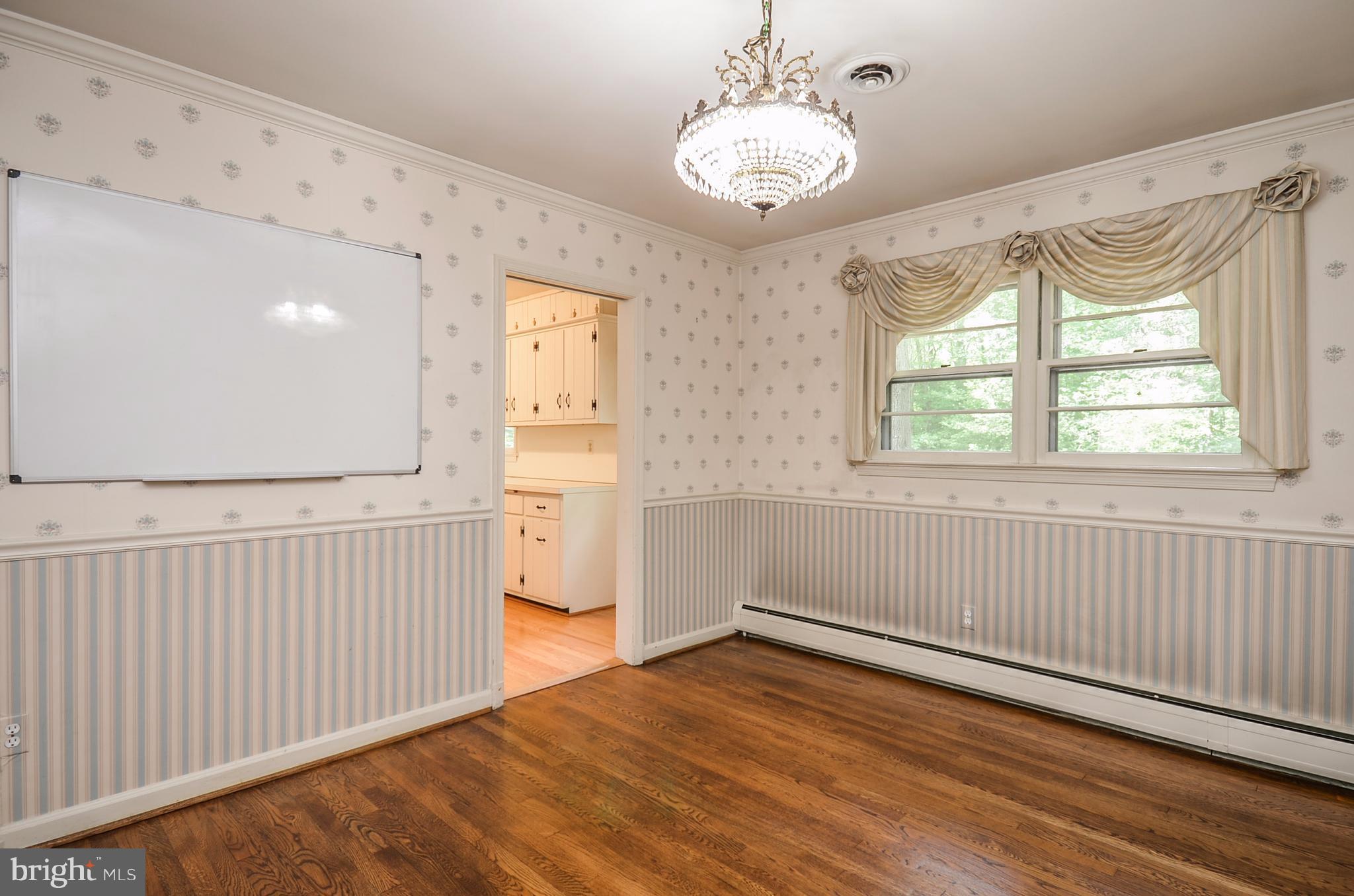 10751 Kinloch Road Silver Spring, MD 20903 - Photo 6 of 30 wooden floor in an empty room with a window