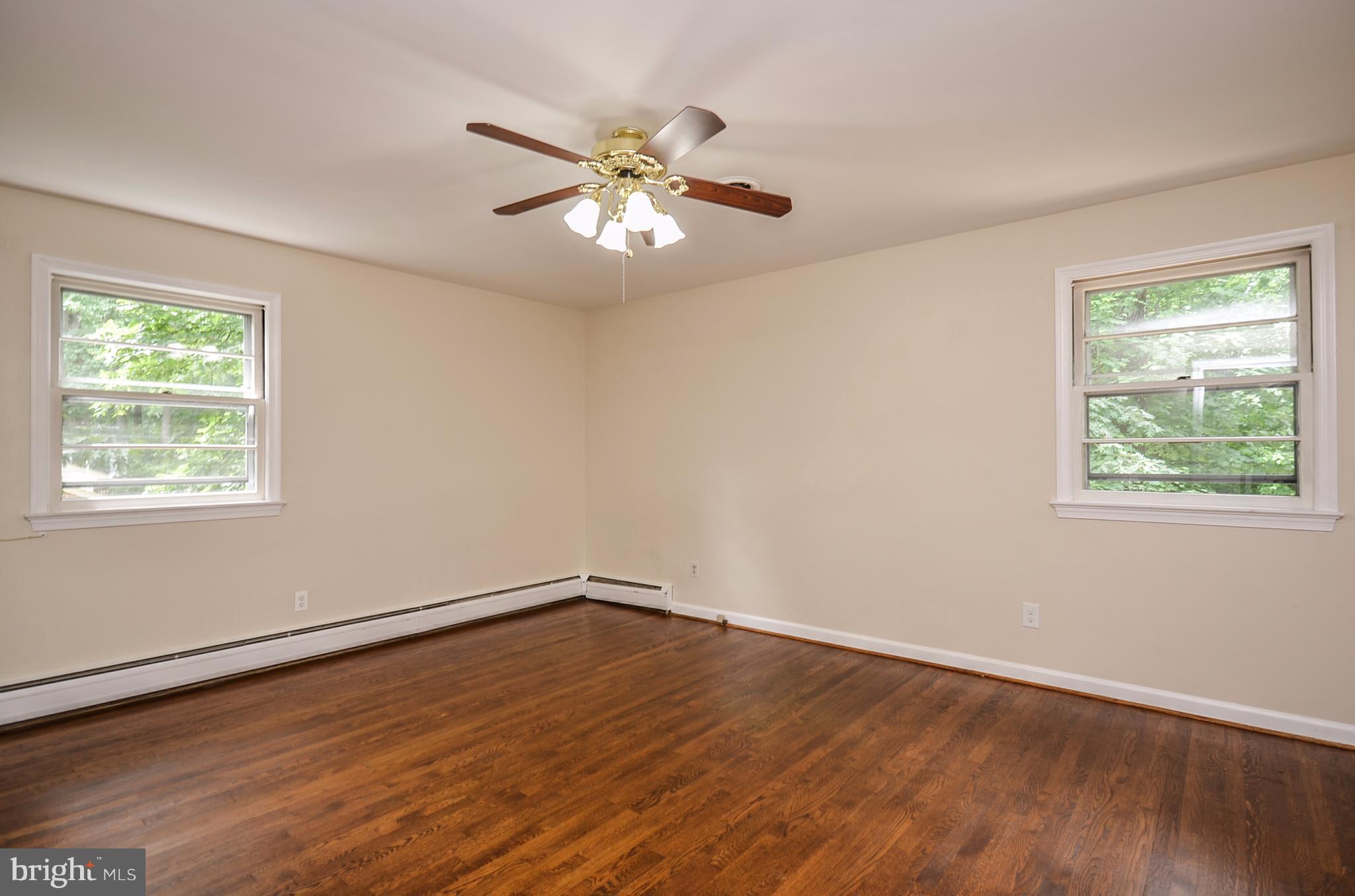 10751 Kinloch Road Silver Spring, MD 20903 - Photo 10 of 30 a view of an empty room with wooden floor and a window