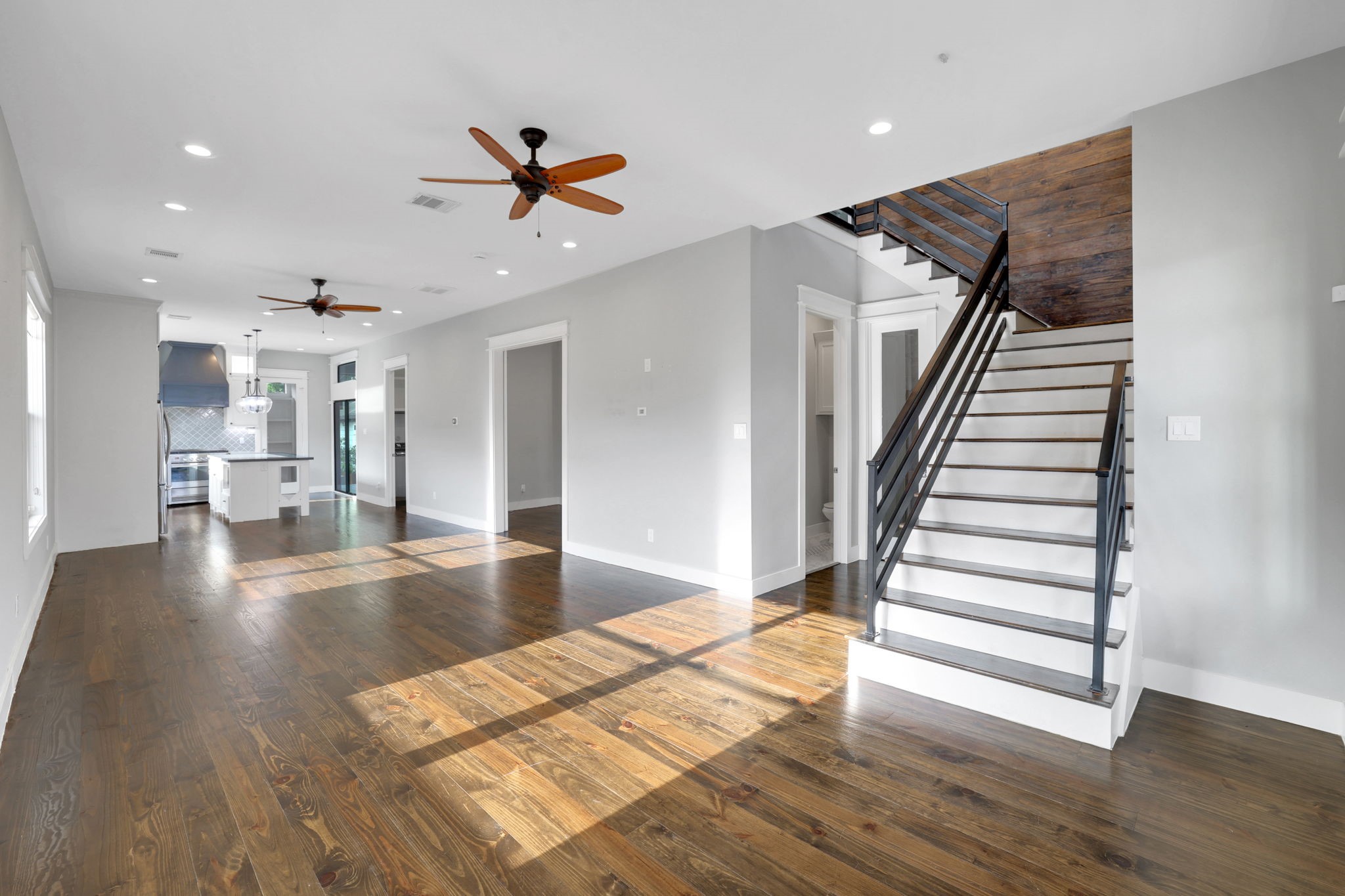 914 Robbie Street Houston, TX 77009 - Photo 8 of 50 a view of a living room with wooden floor and staircase