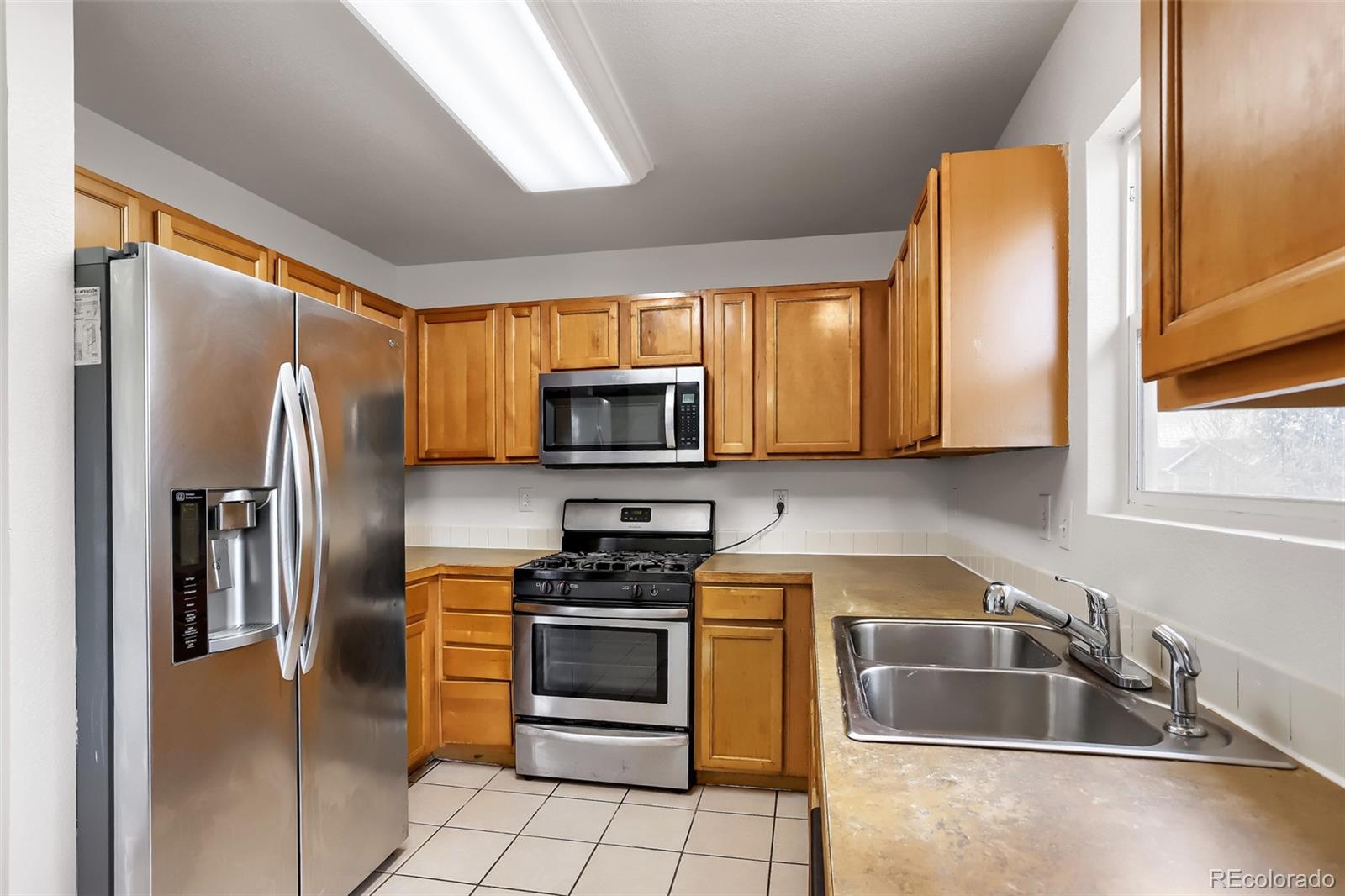 3708 Salida Court Evans, CO 80620 - Photo 11 of 19 a kitchen with stainless steel appliances granite countertop a refrigerator a stove top oven a sink and dishwasher