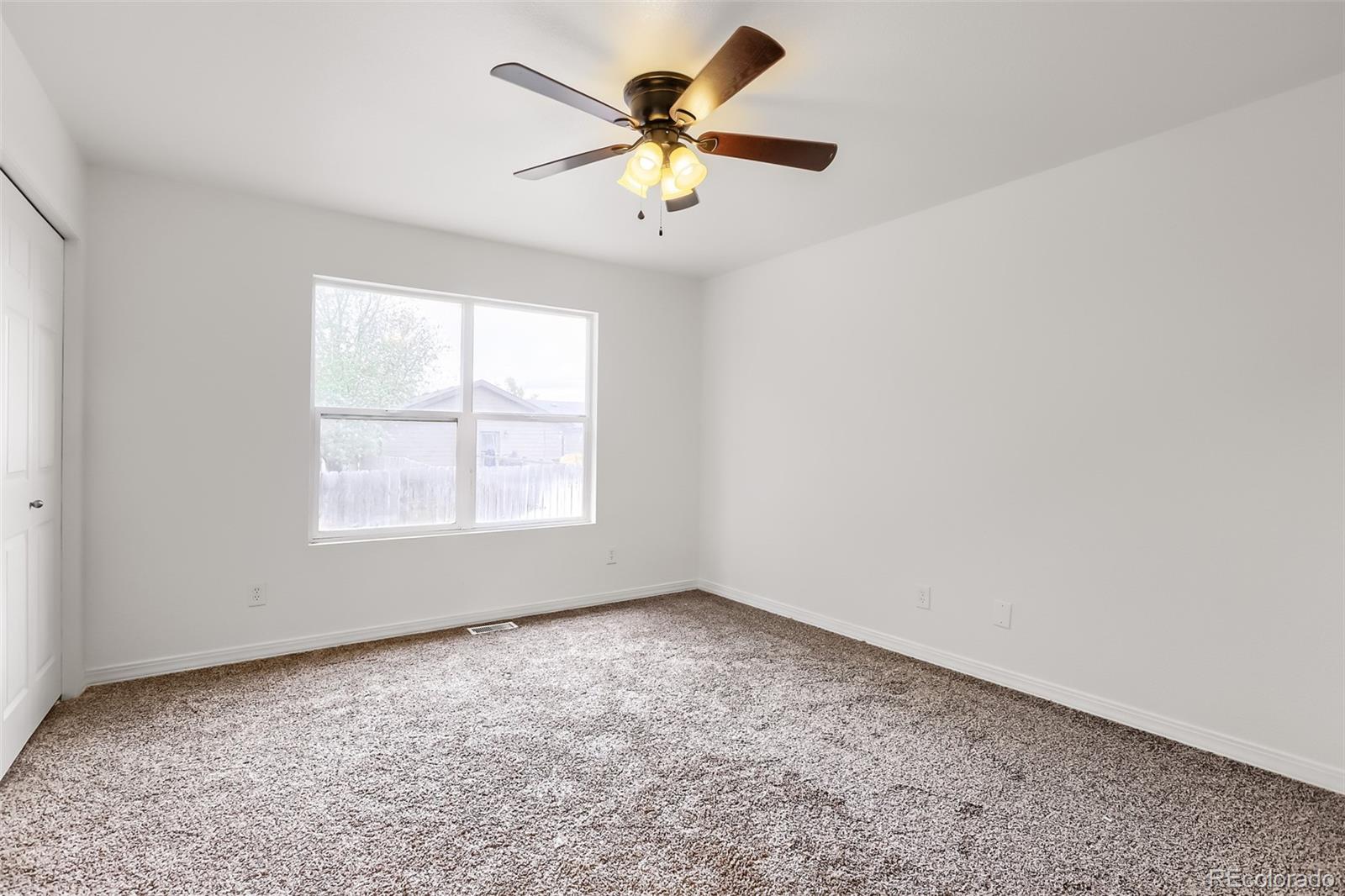 3708 Salida Court Evans, CO 80620 - Photo 12 of 19 wooden floor in an empty room with a window