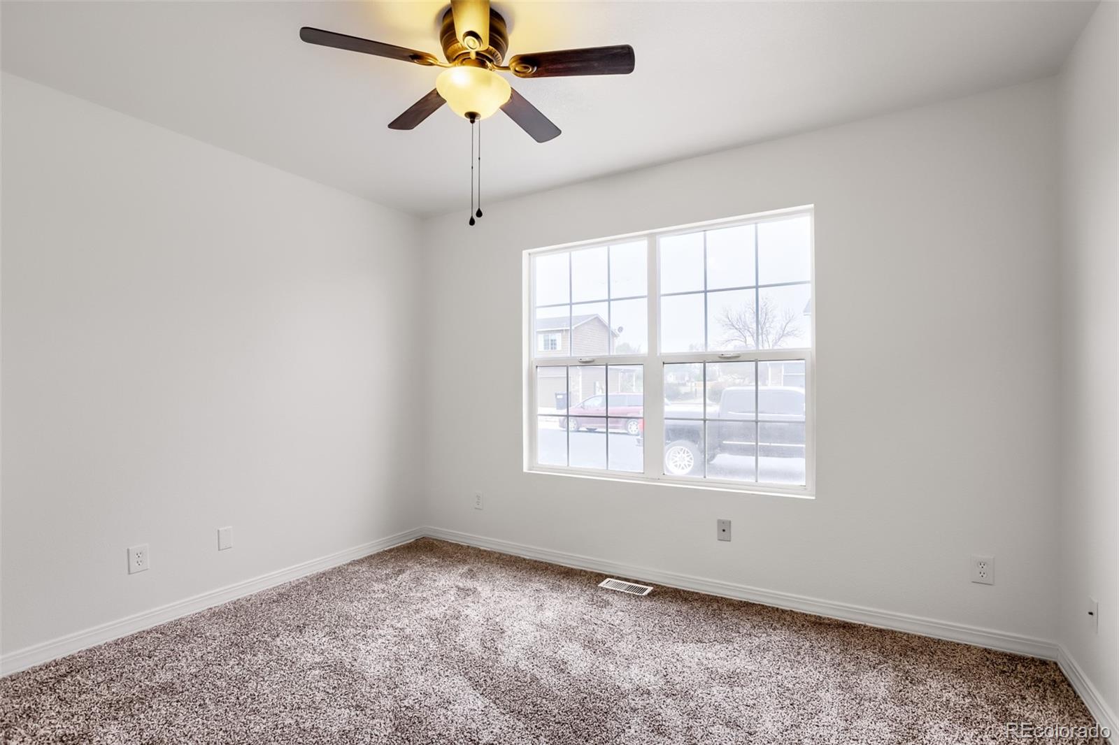 3708 Salida Court Evans, CO 80620 - Photo 14 of 19 an empty room with a window and a fan