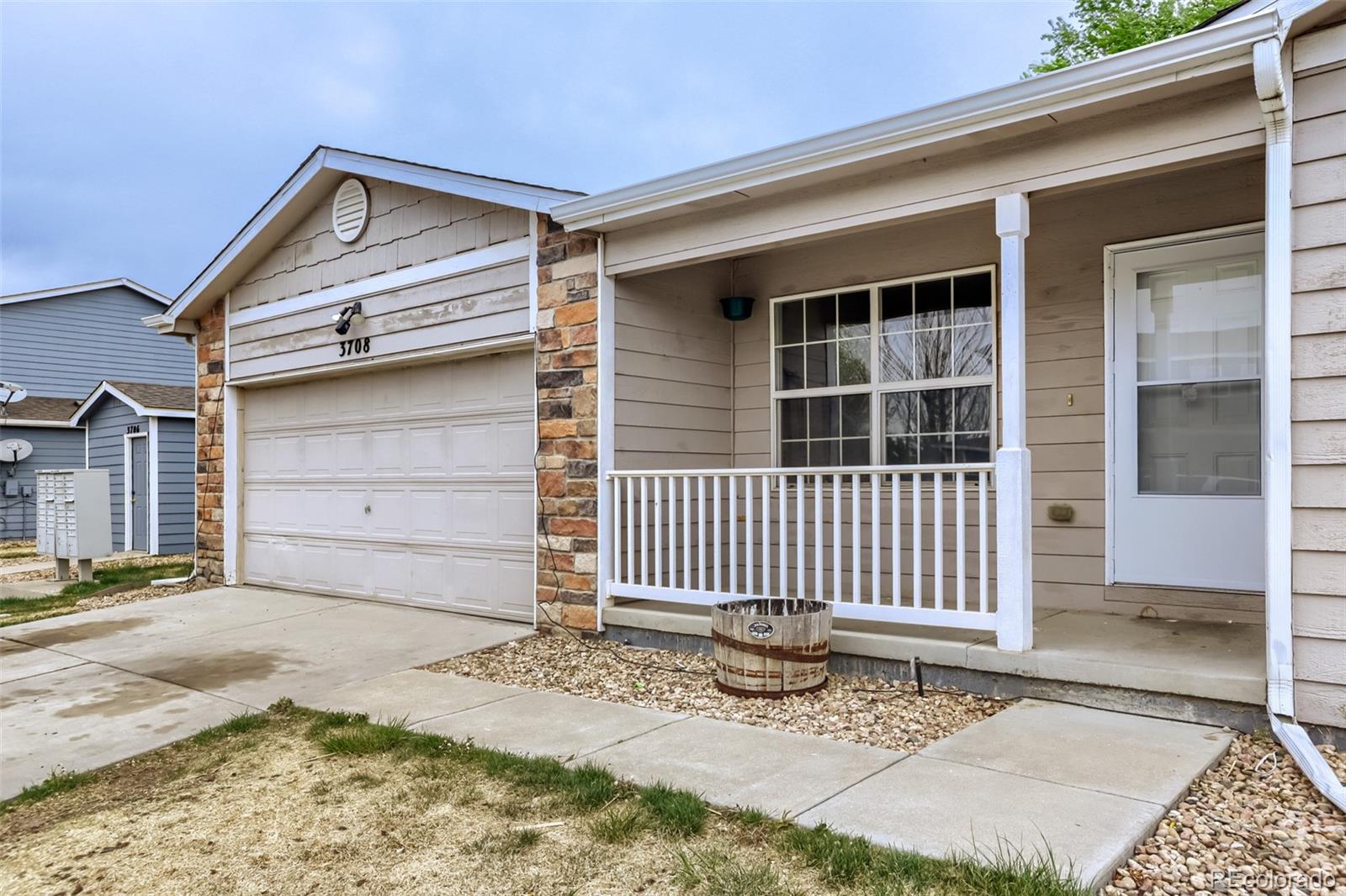 3708 Salida Court Evans, CO 80620 - Photo 2 of 19 a front view of a house with a garage