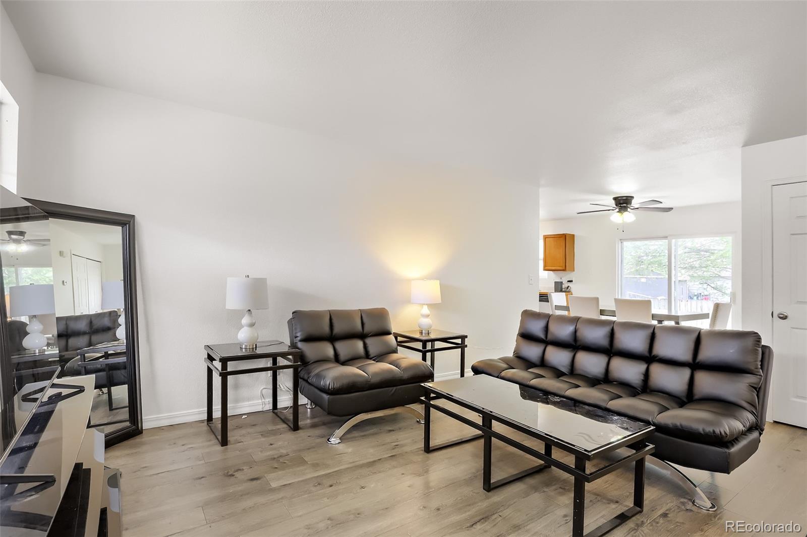 3708 Salida Court Evans, CO 80620 - Photo 5 of 19 a living room with furniture a rug and a flat screen tv