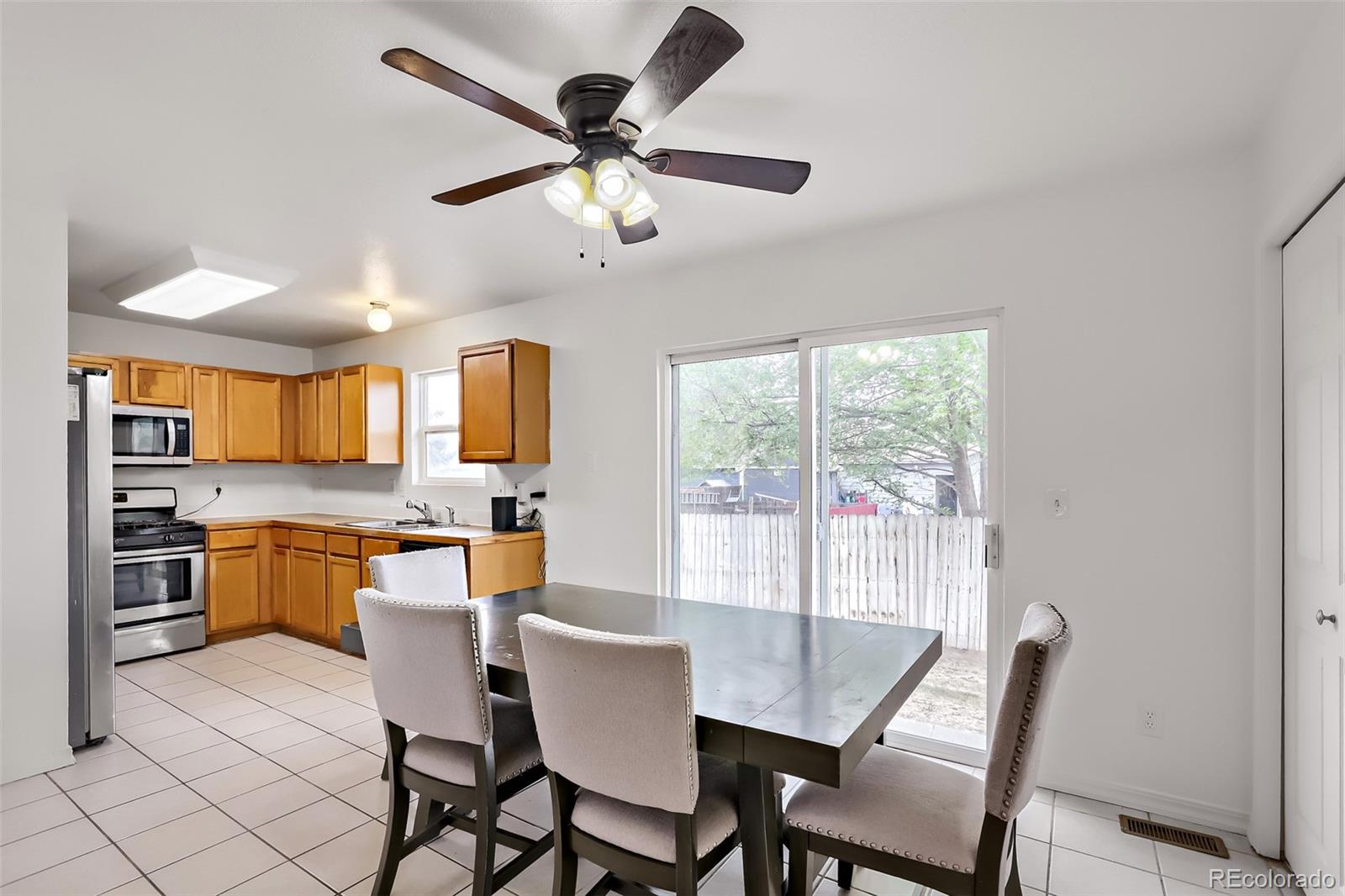 3708 Salida Court Evans, CO 80620 - Photo 7 of 19 a view of a dining room with furniture window and wooden floor