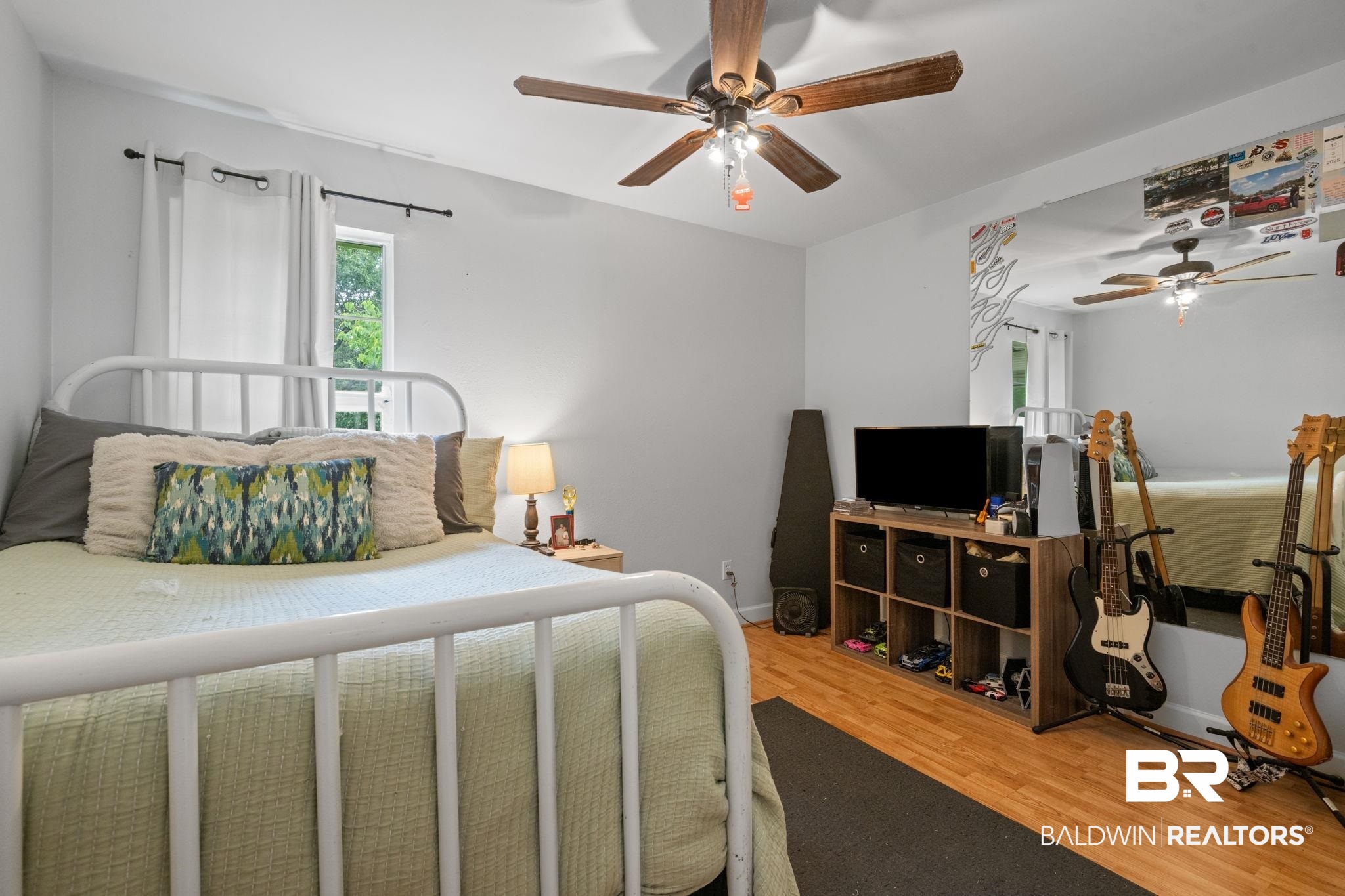 5936 Lundy Road Theodore, AL 36582 - Photo 16 of 32 Room featuring light gray walls, wood-finish flooring, and a ceiling fan with wood-tone blades