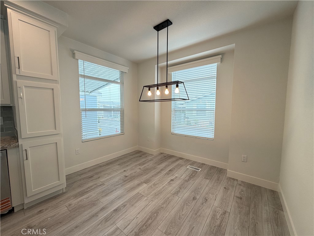 9080 Bloomfield Street, Unit 231 Cypress, CA 90630 - Photo 16 of 20 a view of empty room with wooden floor and fan