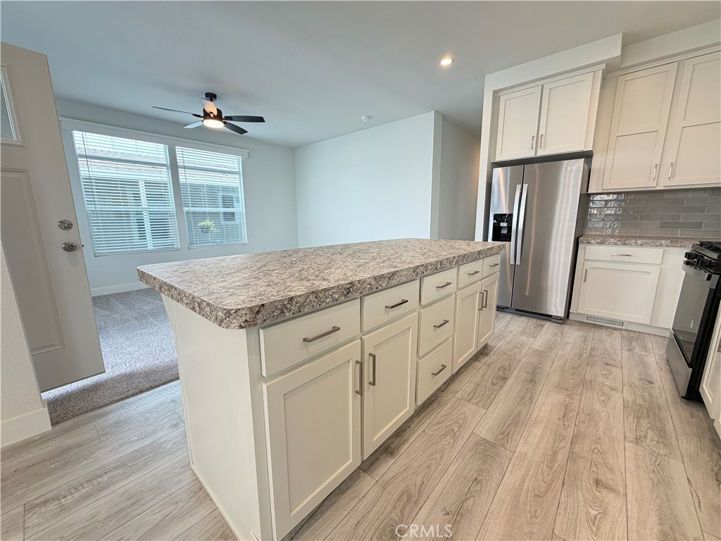 9080 Bloomfield Street, Unit 231 Cypress, CA 90630 - Photo 7 of 20 a kitchen with a sink window and refrigerator