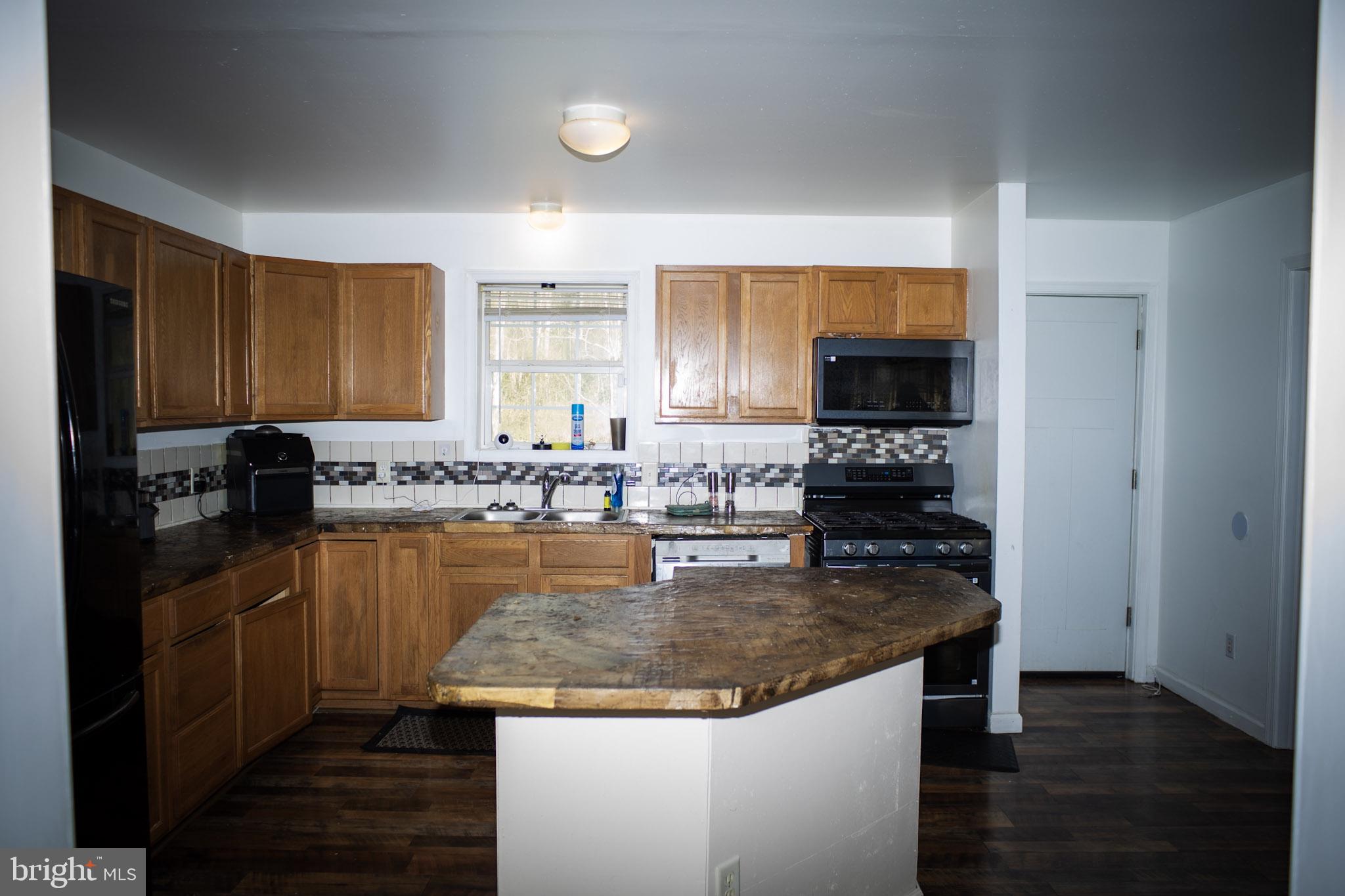 250 Shoemaker Lane Bridgeton, NJ 08302 - Photo 17 of 33 a kitchen with a stove top oven a sink and a refrigerator