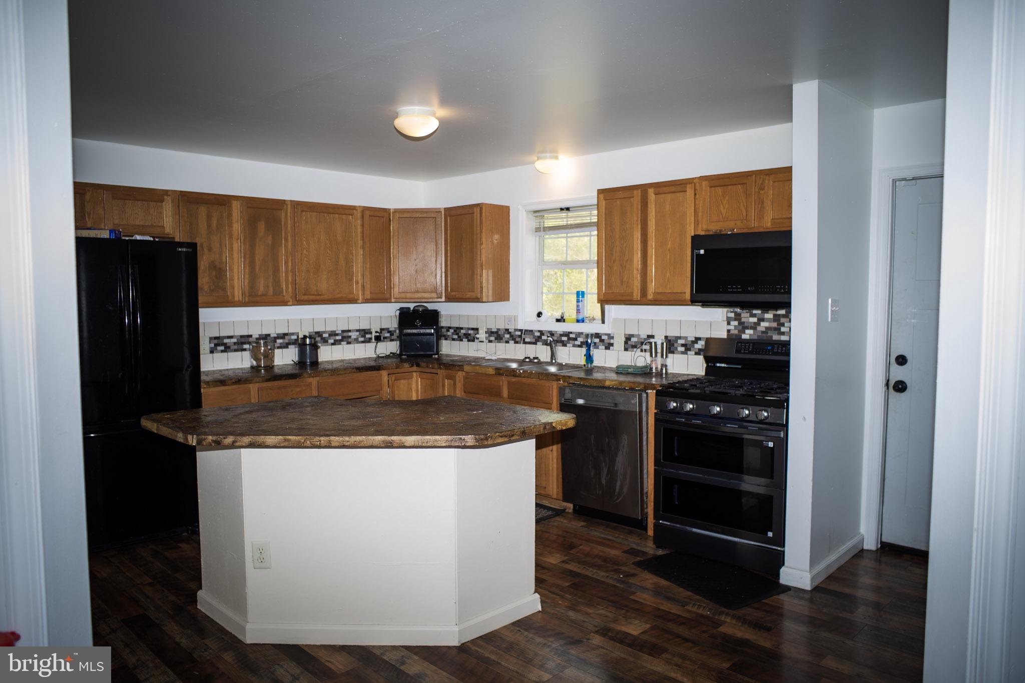250 Shoemaker Lane Bridgeton, NJ 08302 - Photo 18 of 33 a kitchen with stainless steel appliances granite countertop a stove a refrigerator and a sink
