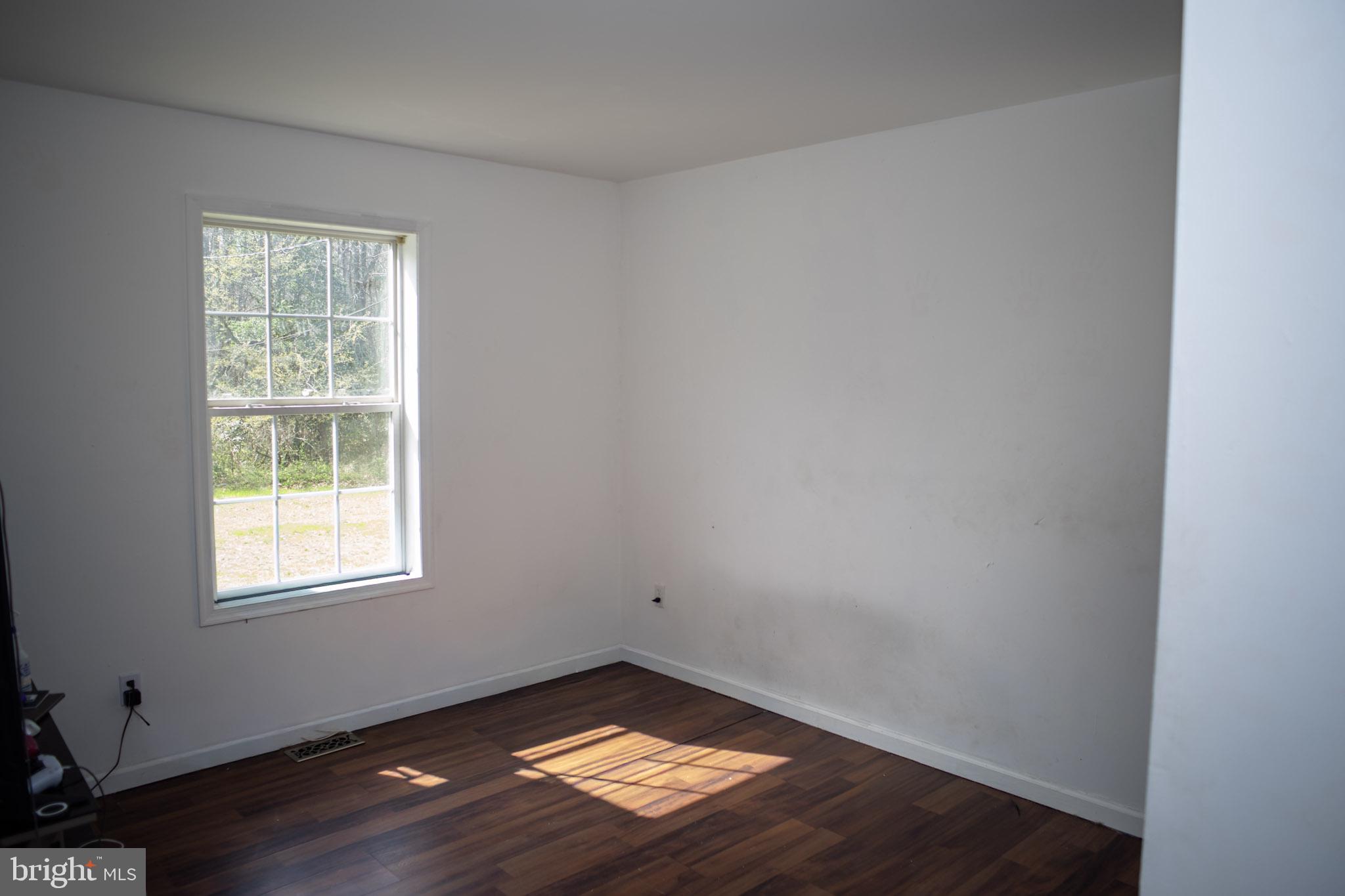 250 Shoemaker Lane Bridgeton, NJ 08302 - Photo 29 of 33 an empty room with wooden floor and windows
