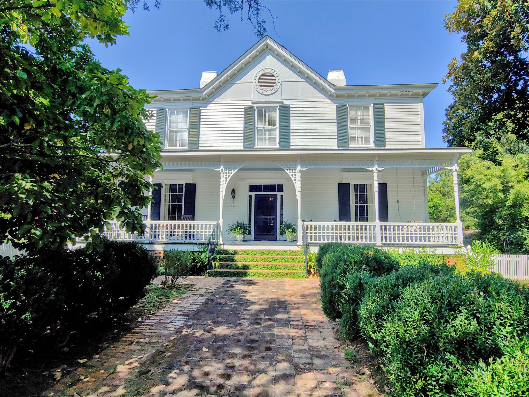 414 Spring Street Washington, GA 30673 - Photo 1 of 42 a front view of a house with garden and porch