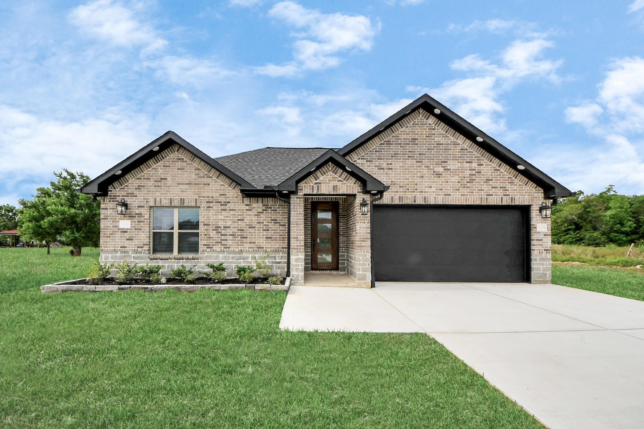 601 Lily Street Prairie View, TX 77484 - Photo 2 of 14 a front view of house with yard and green space
