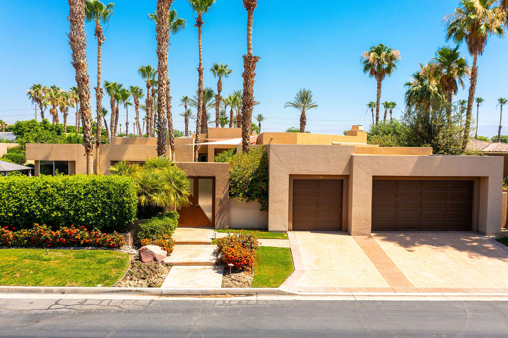 79160 Jack Rabbit Trail La Quinta, CA 92253 - Photo 2 of 48 a front view of a house with a yard and garage