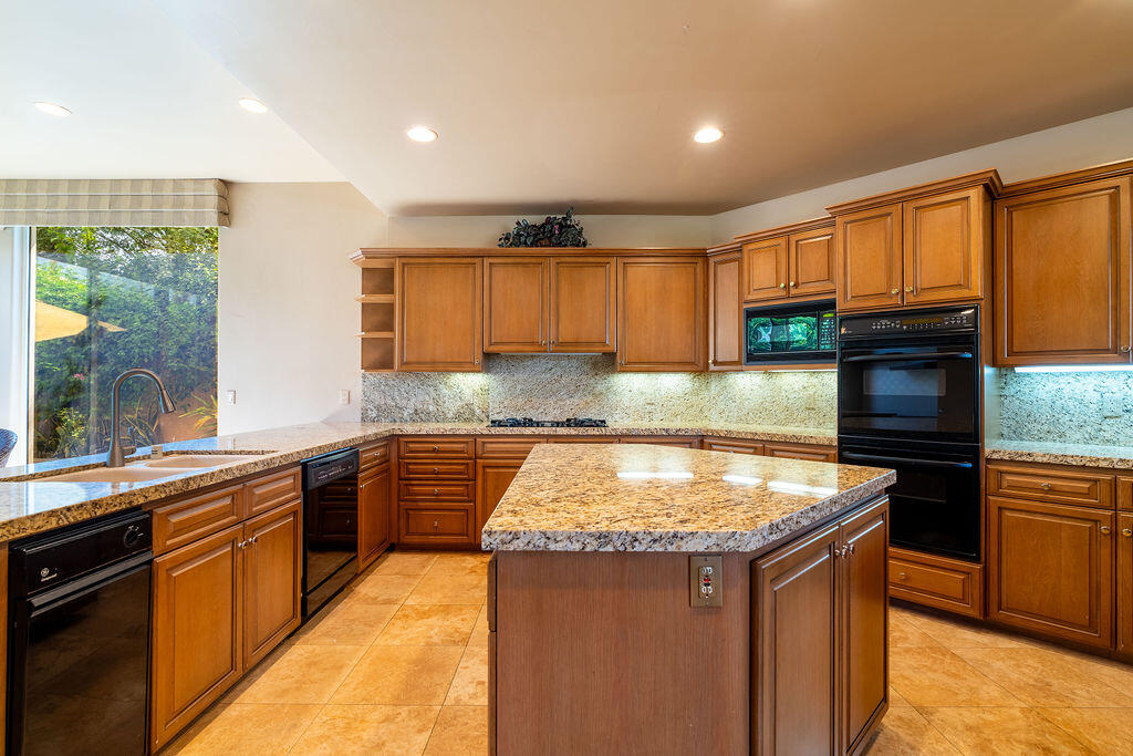 79160 Jack Rabbit Trail La Quinta, CA 92253 - Photo 43 of 48 a kitchen with stainless steel appliances granite countertop a sink stove and refrigerator