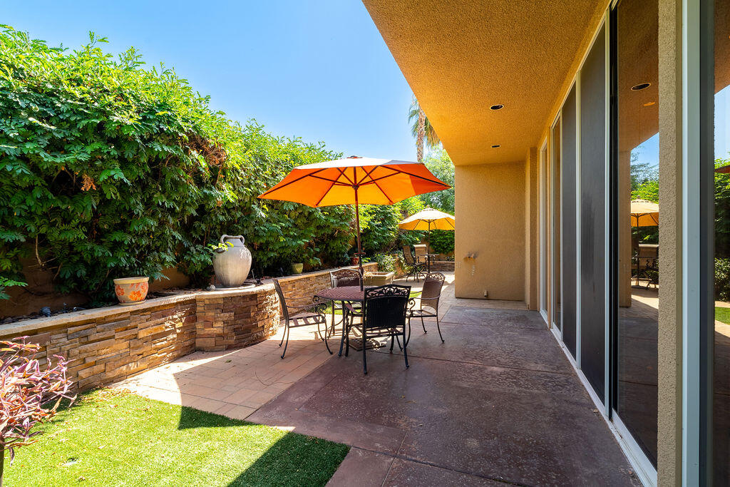 79160 Jack Rabbit Trail La Quinta, CA 92253 - Photo 44 of 48 a view of a patio with table and chairs under an umbrella
