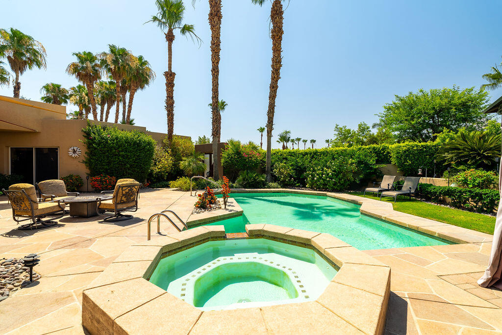 79160 Jack Rabbit Trail La Quinta, CA 92253 - Photo 10 of 48 a view of a swimming pool with a lounge chairs