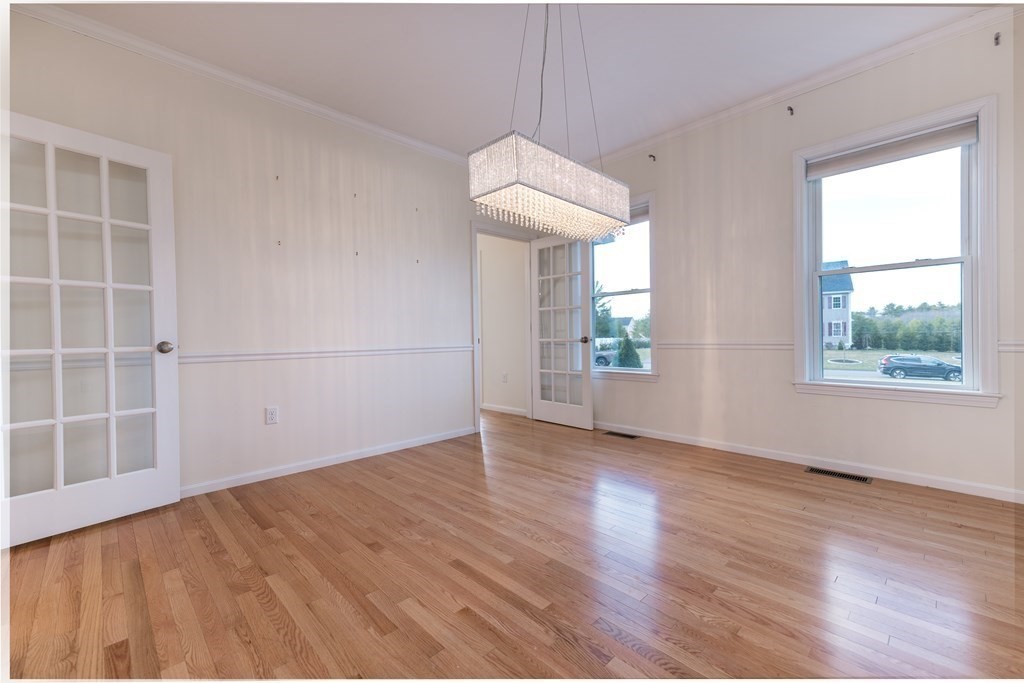 4 Douglas Corner Rochester, MA 02770 - Photo 8 of 42 an empty room with wooden floor and windows